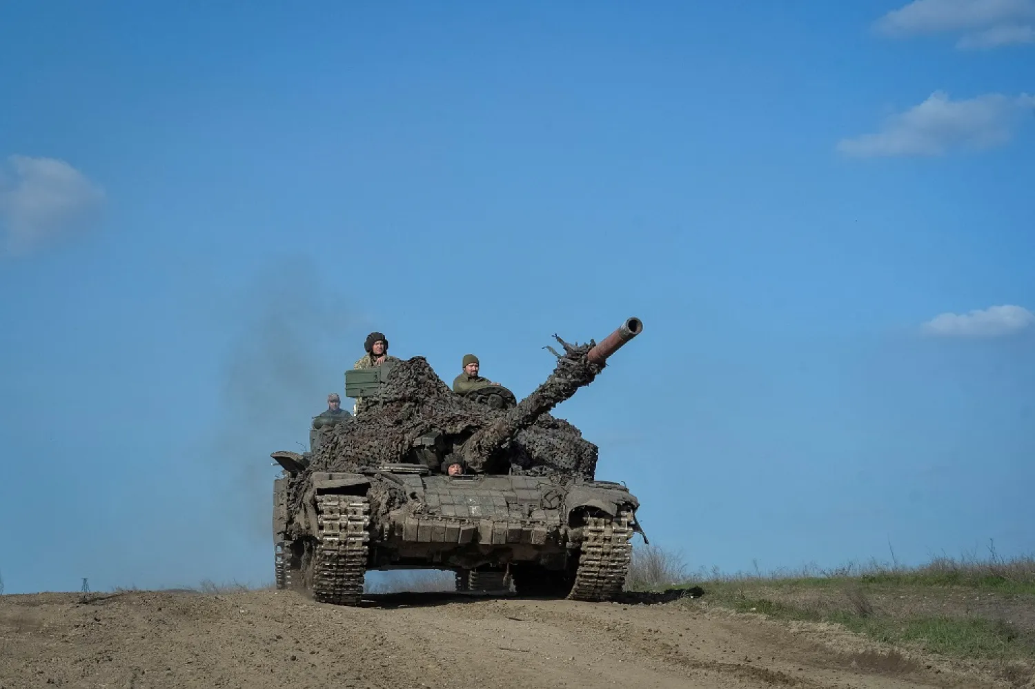 Ukrainian service members ride a tank, as Russia's attack on Ukraine continues, near the front line city of Bakhmut, Ukraine April 10, 2023. (Reuters)