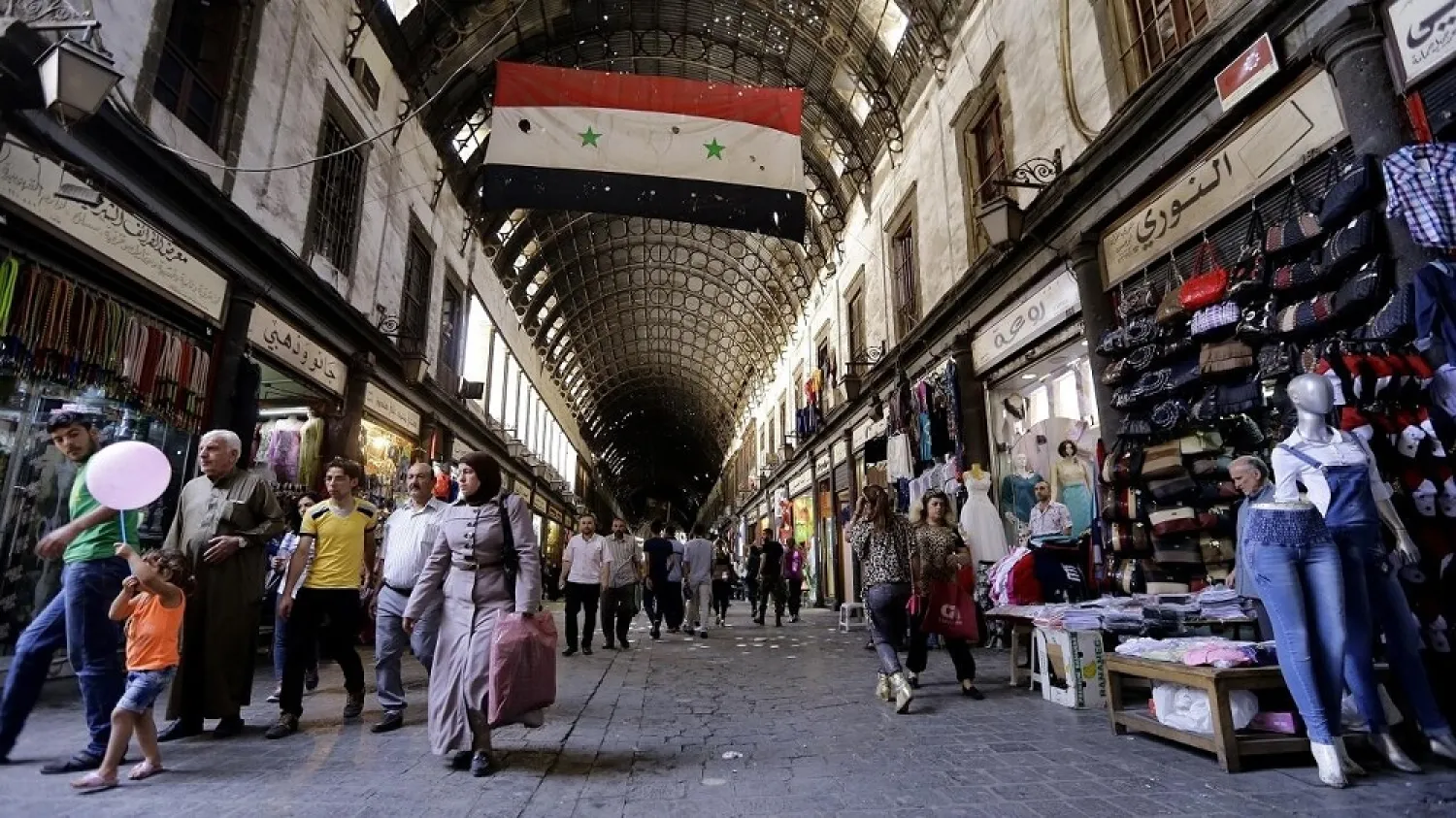 Syrians walk in Damascus' al-Hamidiyah souk on the second day of the Muslim holy month of Ramadan on June 7, 2016. (AFP)