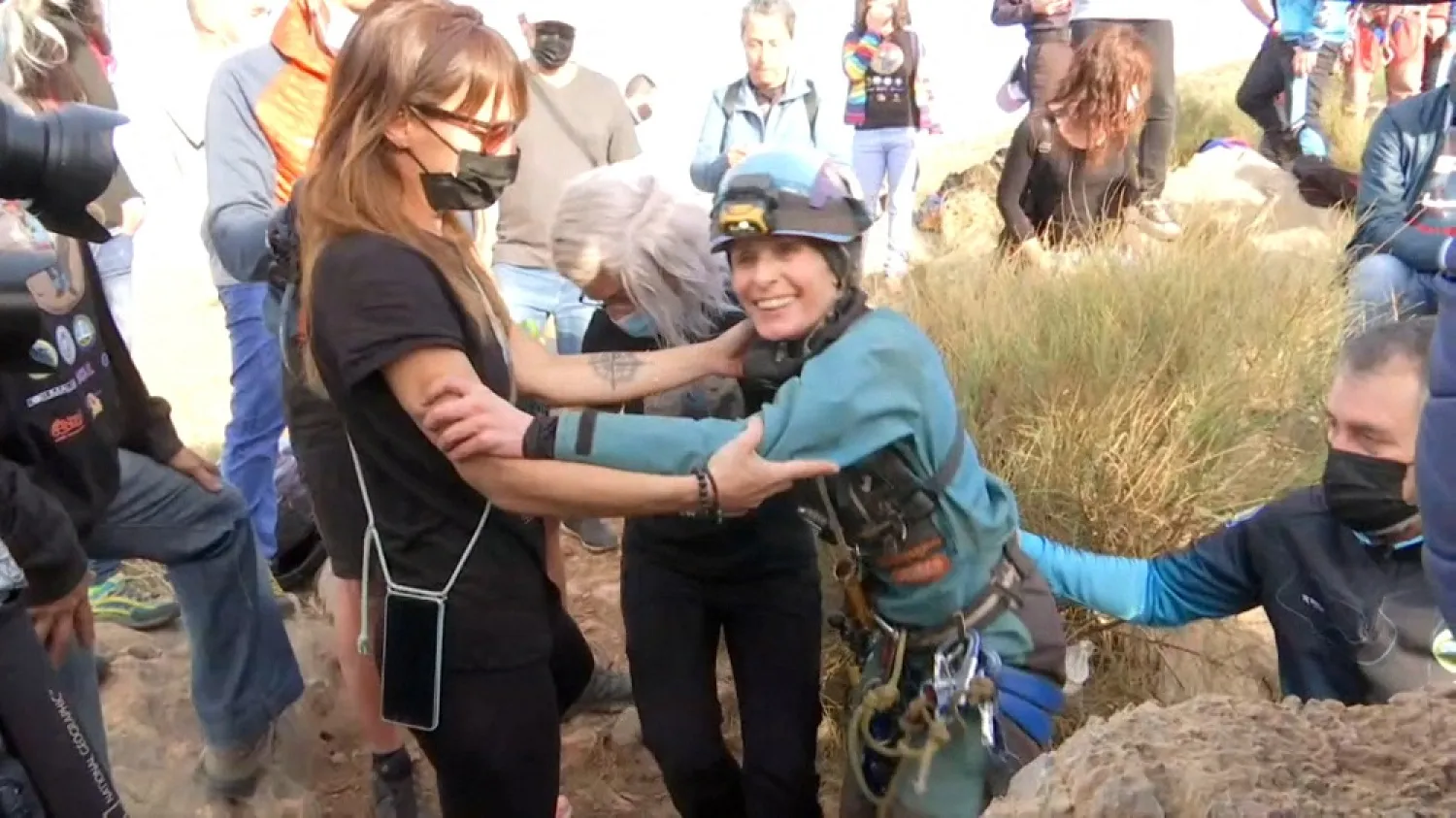 Beatriz Flamini, Spanish mountaineer who has been isolated 500 days in a cave in southern Spain, is seen leaving the cave and hugging teammates in Motril, Spain April 14, 2023 in this screen grab taken from a handout video. (Forta/Handout via Reuters)