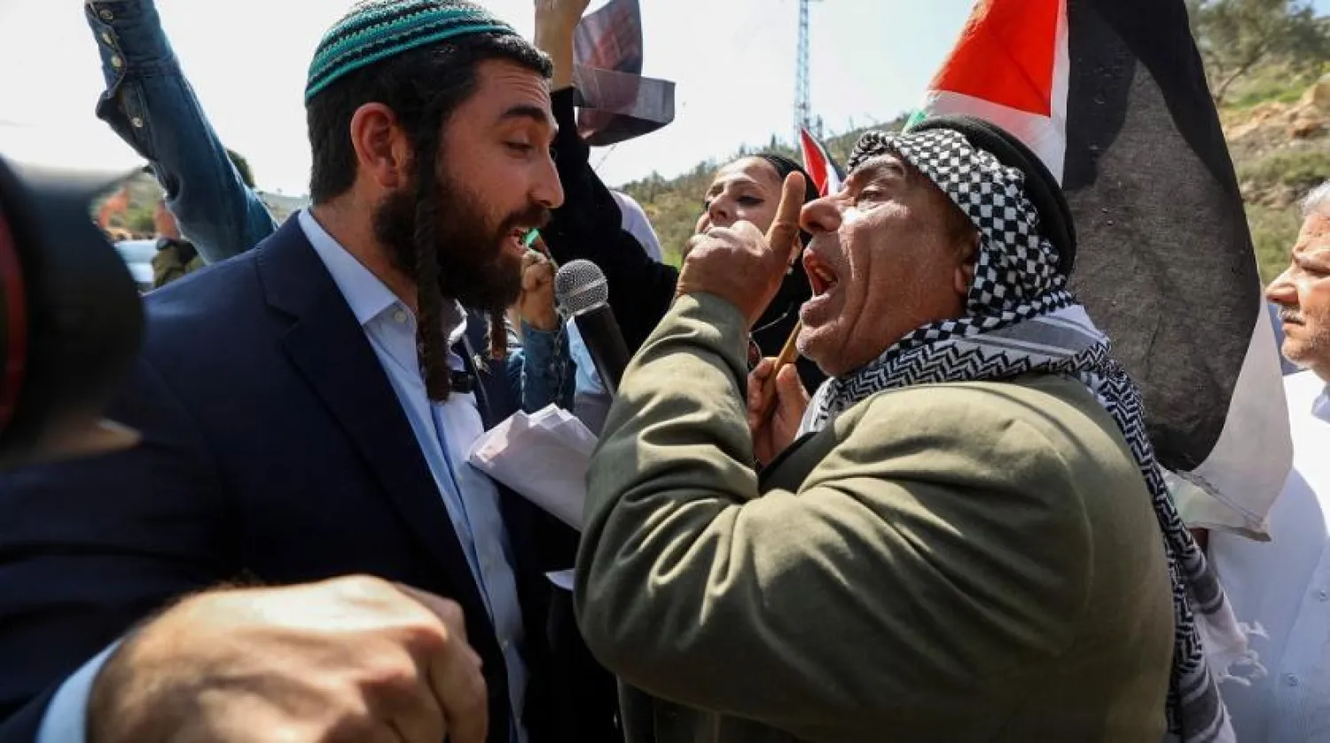 Parliament member for Israel's Religious Zionism party Tzvi Sukkot (L) is confronted as he tries to interrupt a rally by Palestinian and Israeli peace activists protesting at the entrance of Huwara in the occupied West Bank, on March 3, 2023, following deadly violence by Israeli settlers. (AFP)