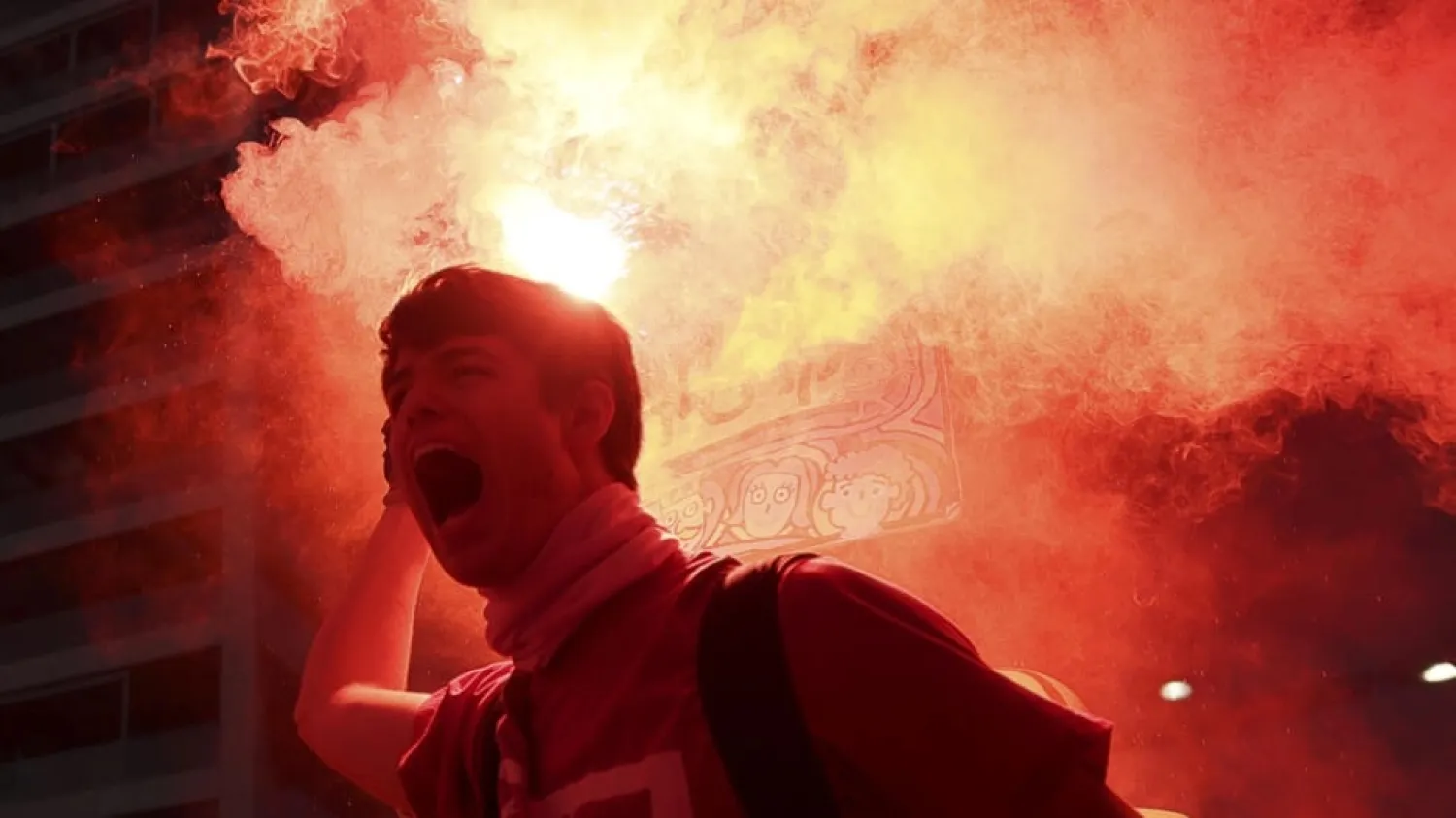 A protester brandishes a flare during protests in Tel Aviv against the government's judicial reform bill. (AFP)