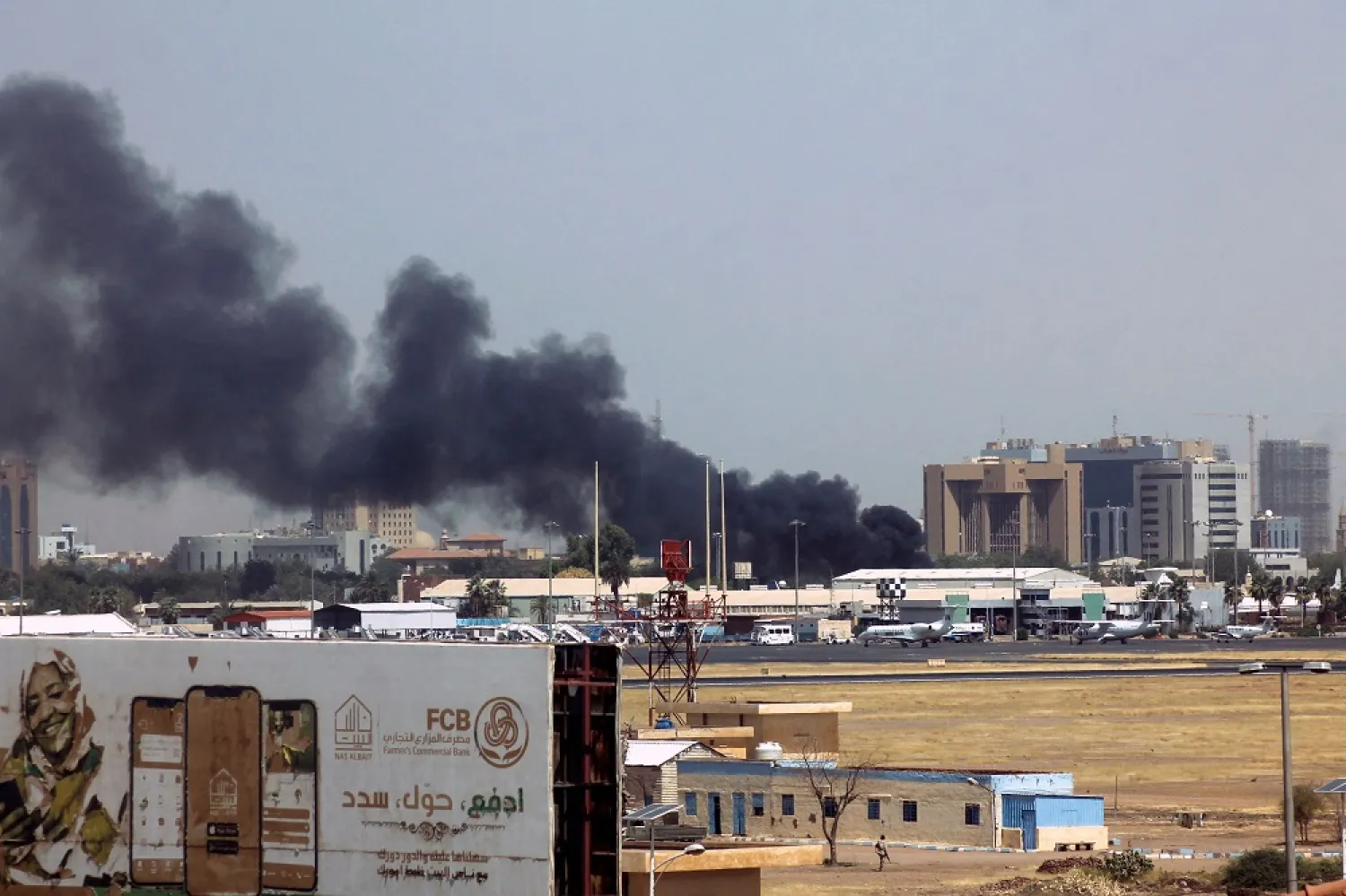Heavy smoke bellows above buildings in the vicinity of the Khartoum airport on April 15, 2023, amid clashes in the Sudanese capital. (AFP)