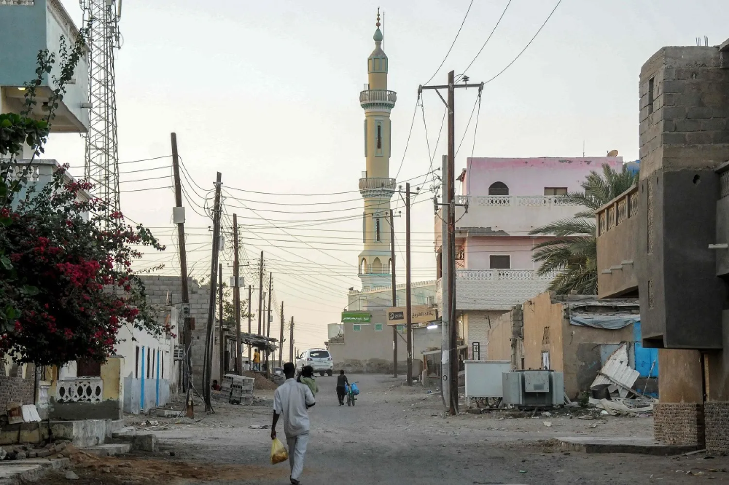 A man walks along a street near a mosque at sunset during the Muslim holy month of Ramadan in Port Sudan on April 18, 2023. (AFP)