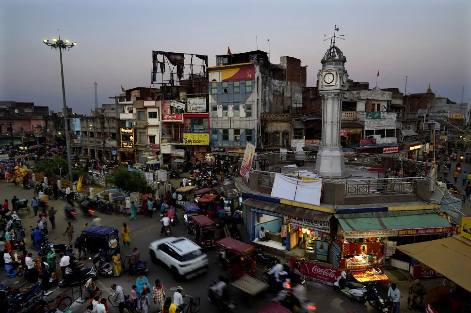 Commuters walk and drive past city's main circle, in Ayodhya, India, March 28, 2023. (AP)