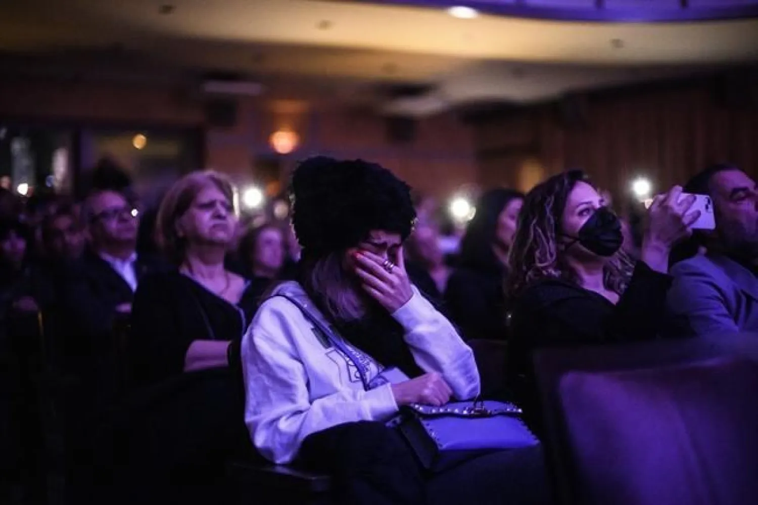People grieve during a ceremony marking the three-year anniversary of the downing of flight PS752, in Toronto on Sunday, January 8, 2023. THE CANADIAN PRESS/Christopher Katsarov