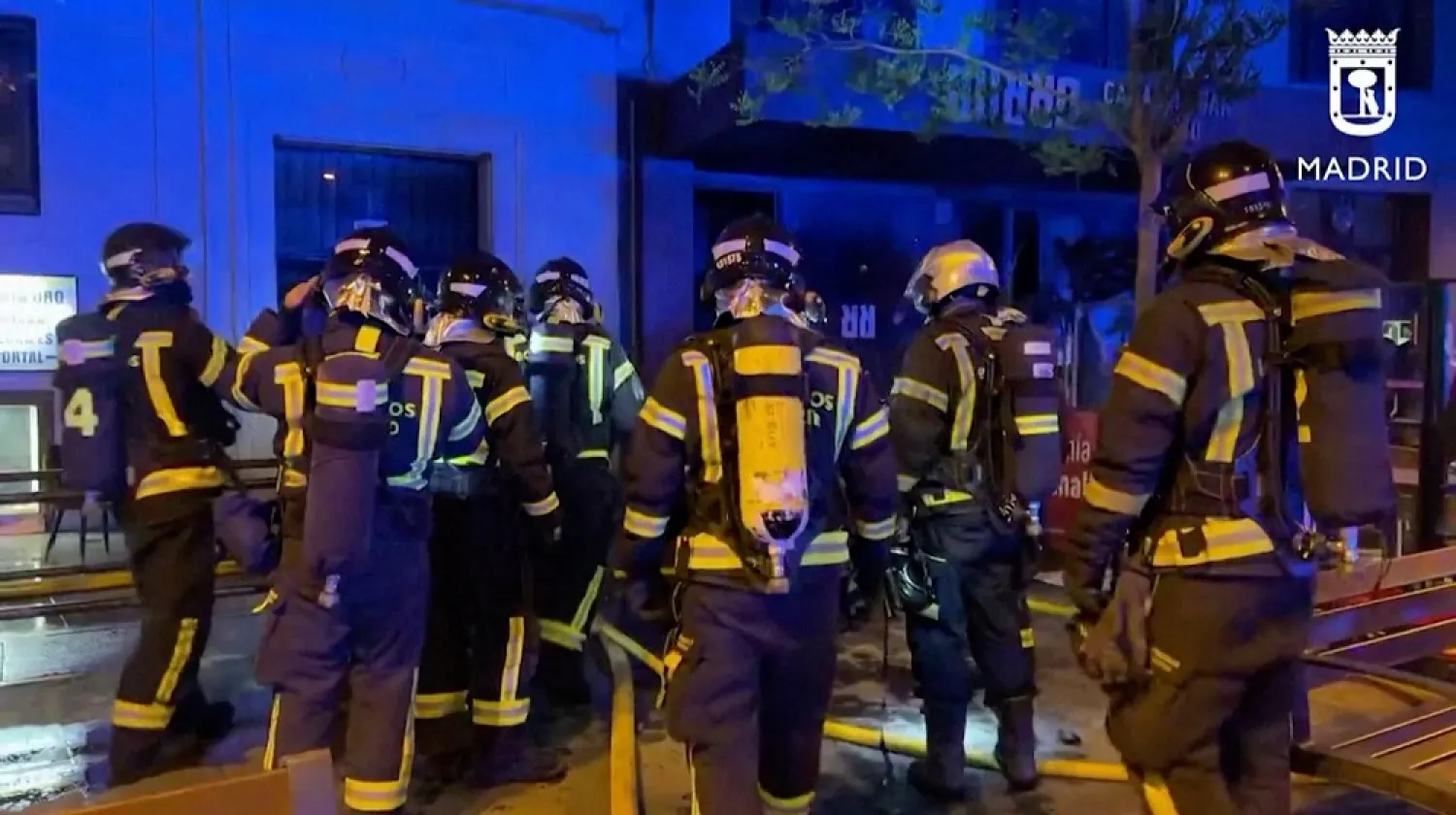 Firefighters gather outside a restaurant following a fire, in Madrid, Spain, April 21, 2023, in this screen grab taken from a handout video. (Madrid Emergency Service/Handout via Reuters)