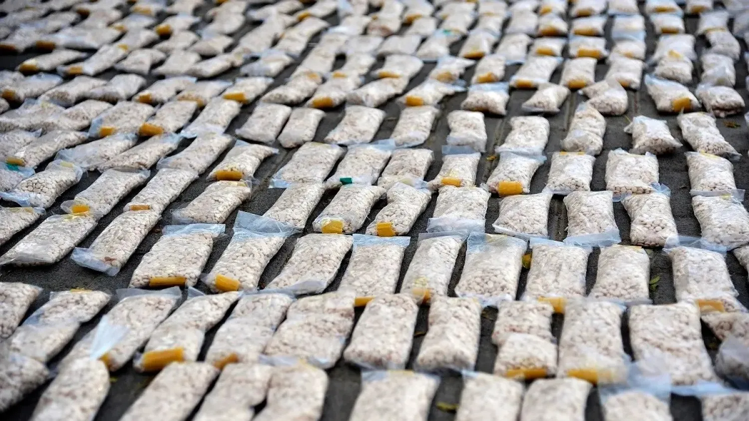 In this photo released by the Syrian official news agency SANA, Syrian authorities display Captagon pills, in rural Damascus, Nov. 30, 2021. (AP)