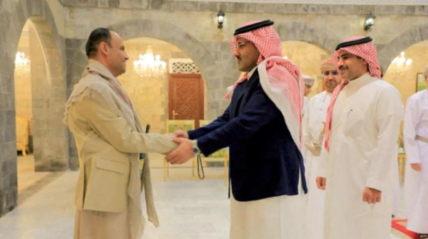 Saudi ambassador to Yemen, Mohammed Al-Jaber, shakes hands with Houthi leader Mehdi al-Mashat in Sanaa three weeks ago (Reuters)
