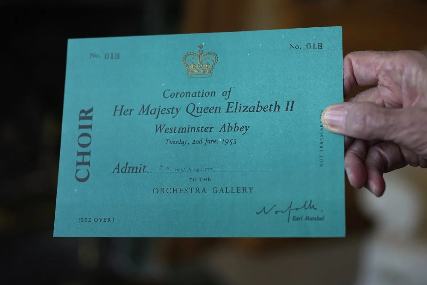 James Wilkinson displays his invitation for Queen Elizabeth II's coronation where he performed as a Westminster Abbey chorister on June 2, 1953, during an interview in London, April 17, 2023. (AP)