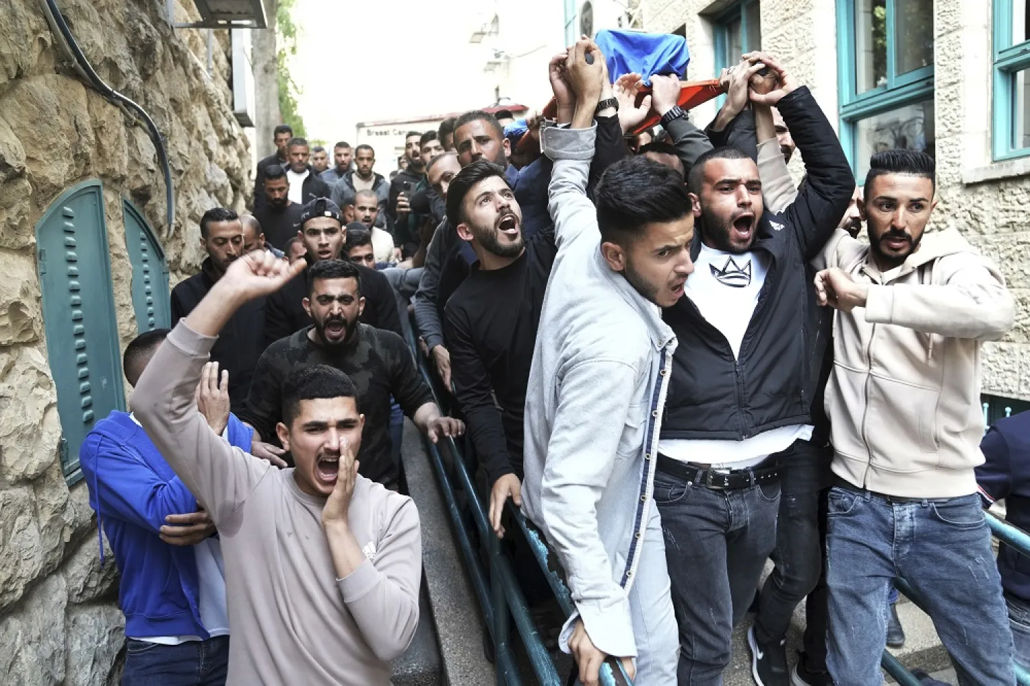 Mourners carry the body of 16-year-old Palestinian Mustafa Sabah, during his funeral in the town of Tuqu', near the West Bank city of Bethlehem, Friday, April 28, 2023. (AP)
