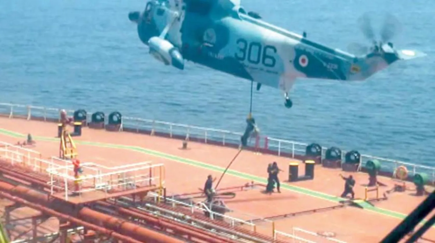 Iranian forces land on board an oil tanker carrying the flag of the Marshall Islands in the Gulf of Oman (AFP)