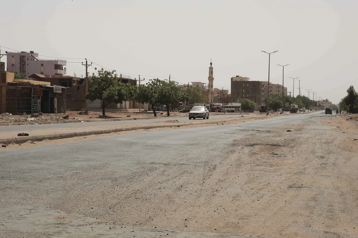 A vehicle crosses an empty street in Khartoum, Sudan, Saturday, April 29, 2023, as gunfire and heavy artillery fire continued despite the extension of a ceasefire between the country's two top generals. (AP)