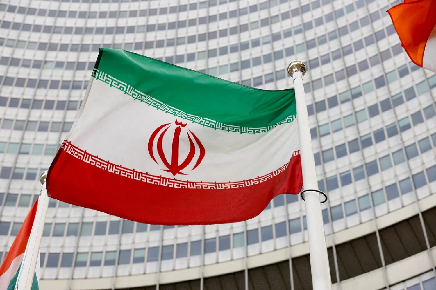 The Iranian flag waves in front of the International Atomic Energy Agency (IAEA) headquarters in Vienna, Austria May 23, 2021. (Reuters)