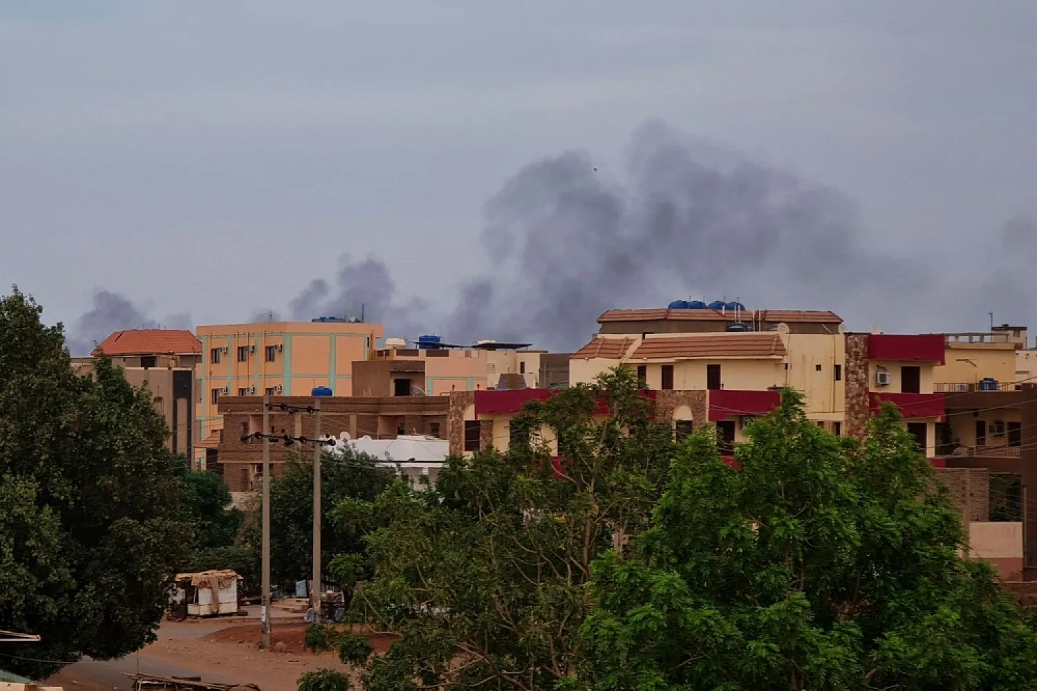 Smoke billows over residential buildings in Khartoum on April 30, 2023 as deadly clashes between rival generals' forces have entered their third week. (AFP)