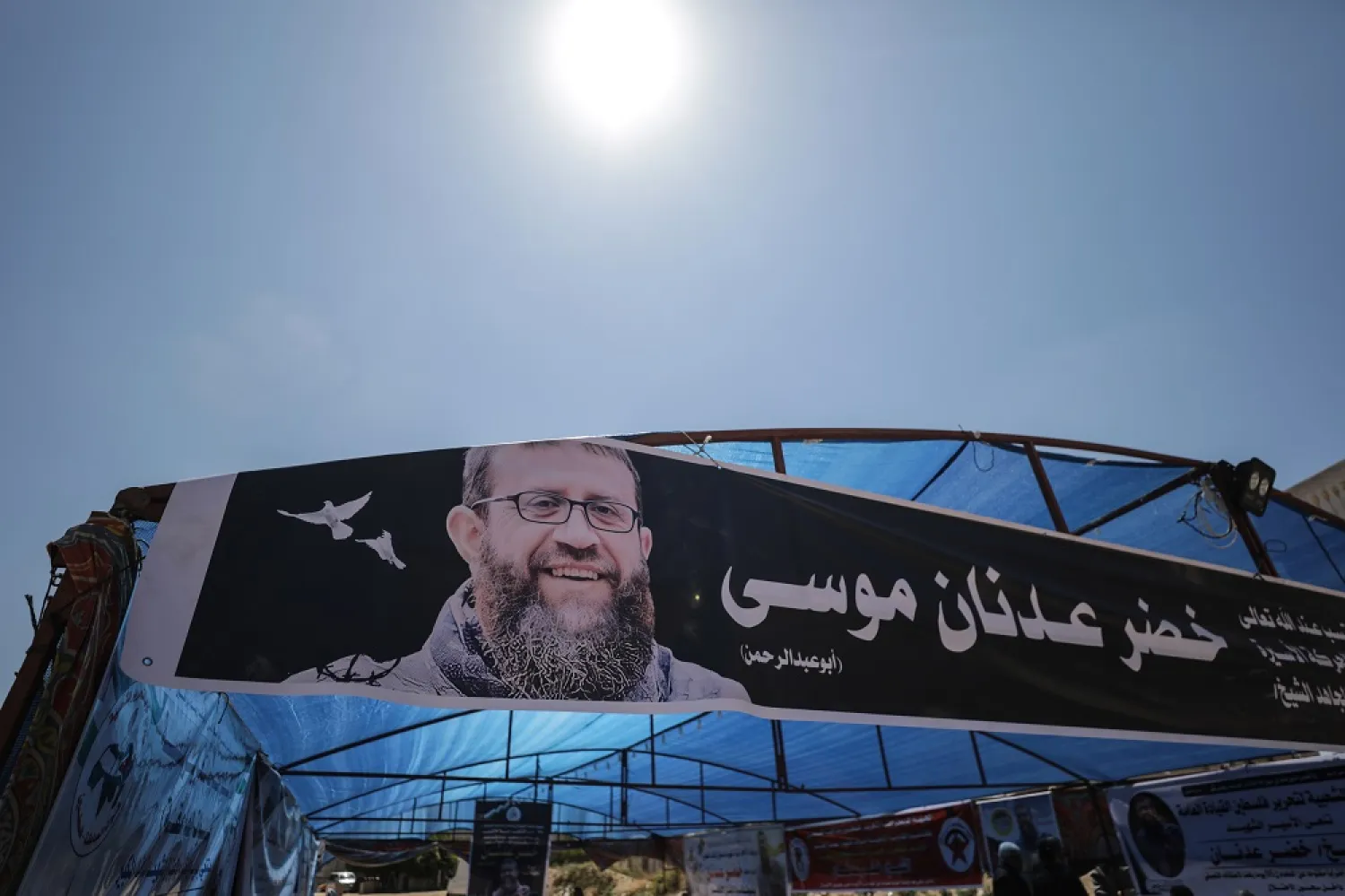 A banner showing the picture of late Palestinian Islamic Jihad member Khader Adnan hangs during an event held in Gaza City following his death, 02 May 2023. (EPA)