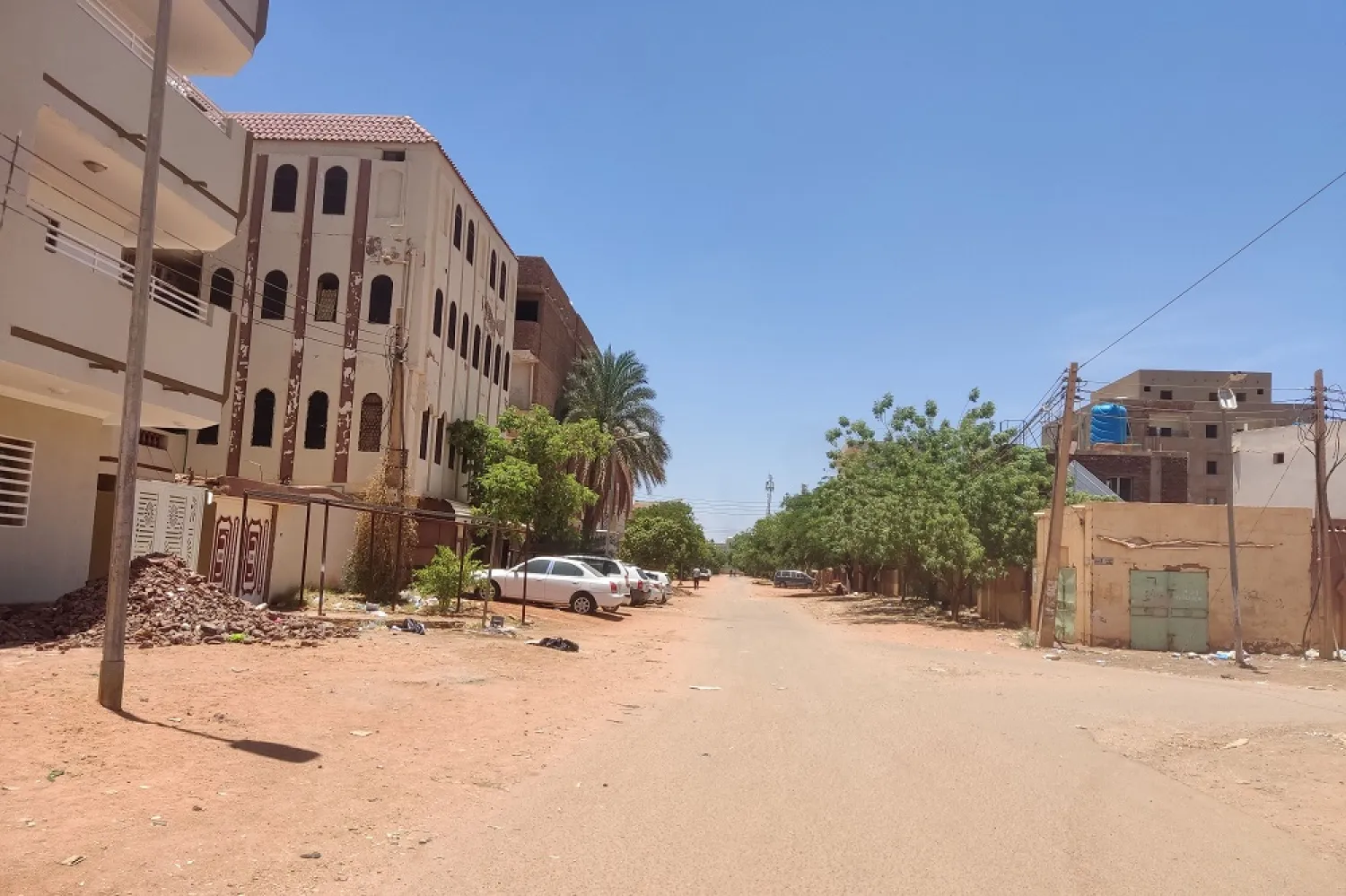 People walk on an almost empty street in southern Khartoum, on May 2, 2023. (AFP)