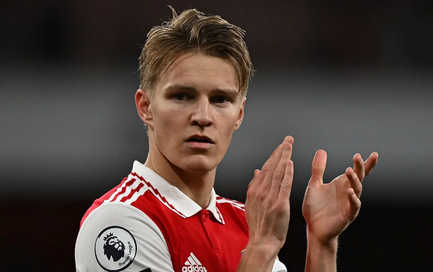 Arsenal's Norwegian midfielder Martin Odegaard applauds the fans following the English Premier League football match between Arsenal and Chelsea at the Emirates Stadium, in London, on May 2, 2023. (AFP)
