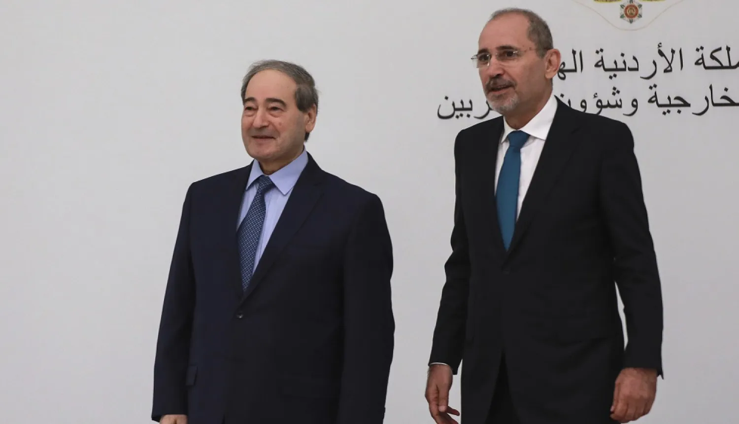 Jordan's Foreign Minister Ayman al-Safadi, right, arrives with his Syrian counterpart Faisal al-Mekdad to attend a regional consultative meeting held in Amman, Jordan, Monday, May 1, 2023. (AP)