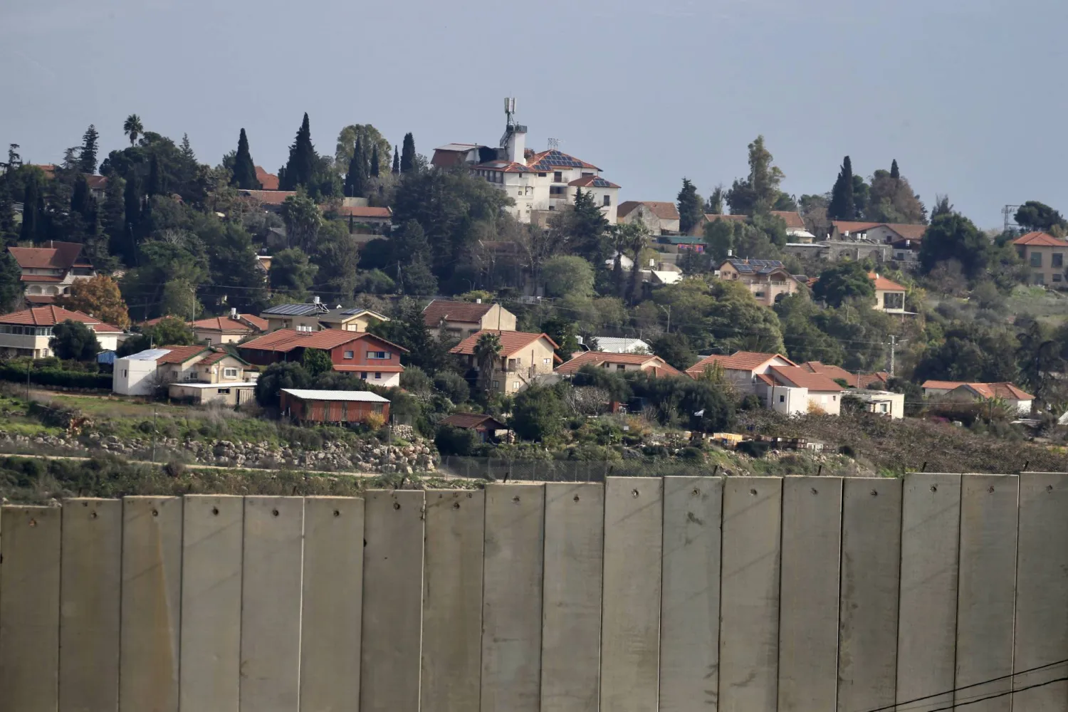 The border wall between Lebanon and Israel and the Israeli Metula town (background), as seen from Kafr Kila village, in southern Lebanon, 31 December 2023. EPA/STR