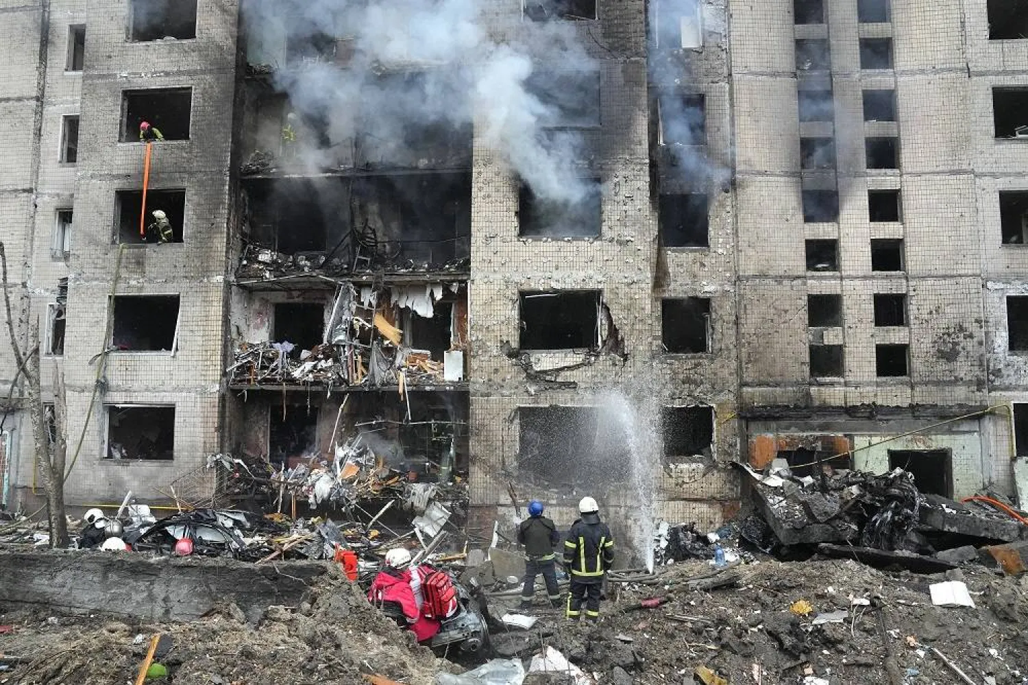 Firefighters work to extinguish a fire in a destroyed apartment building after a Russian attack in Kyiv, Ukraine, Tuesday, Jan. 2, 2024. (AP)