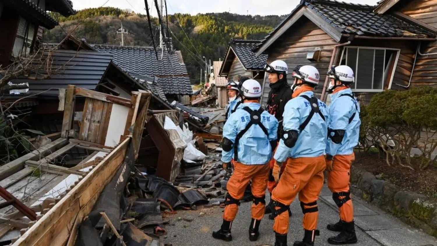 Firefighters inspect collapsed wooden houses in the city of Wajima on Japan's Noto Peninsula, the area hardest hit by the New Year's Day earthquake. Kazuhiro NOGI / AFP
