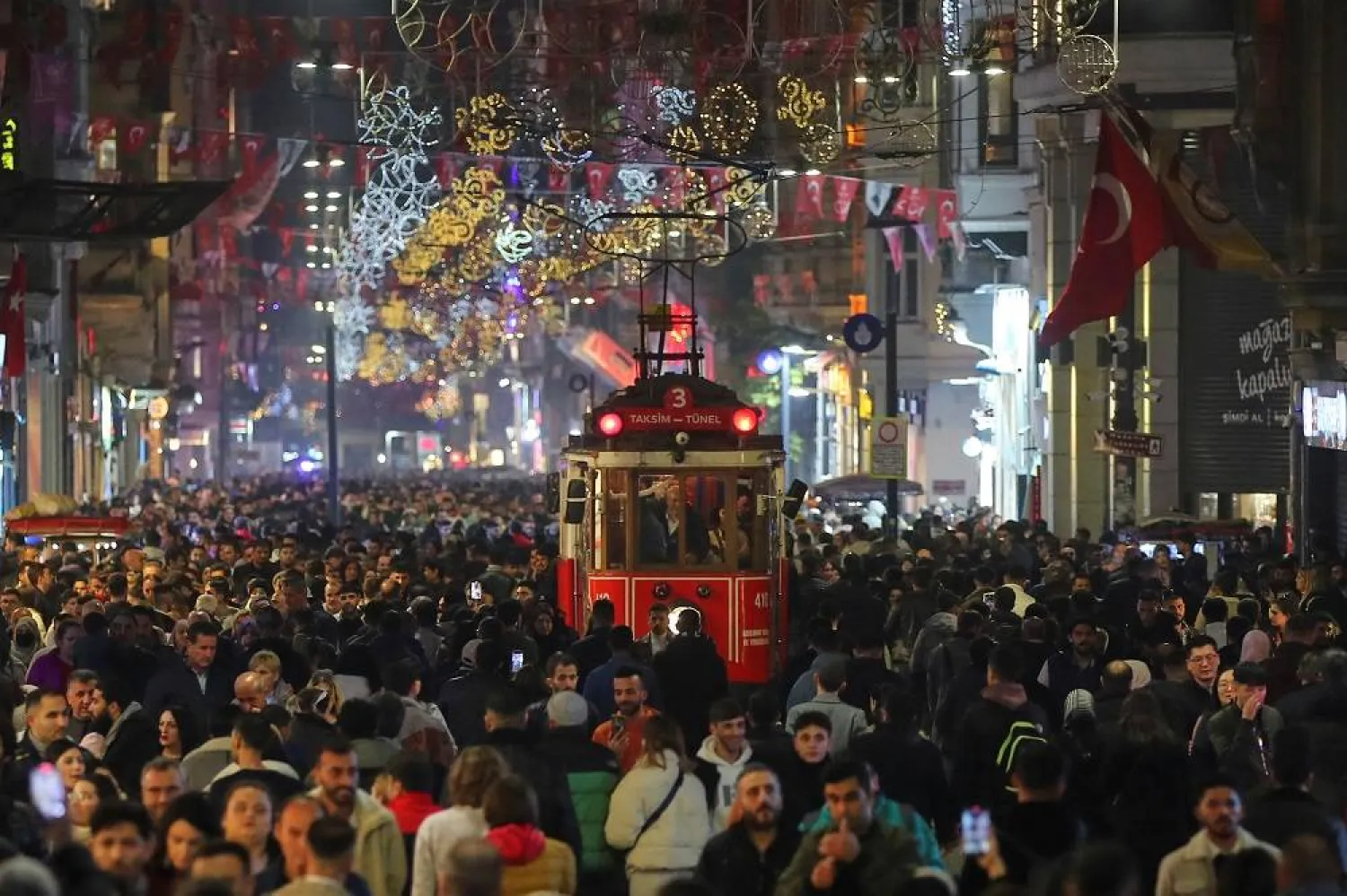 People stroll at the main shopping and pedestrian street of Istiklal on New Year's eve in central Istanbul, Türkiye December 31, 2023. (Reuters)