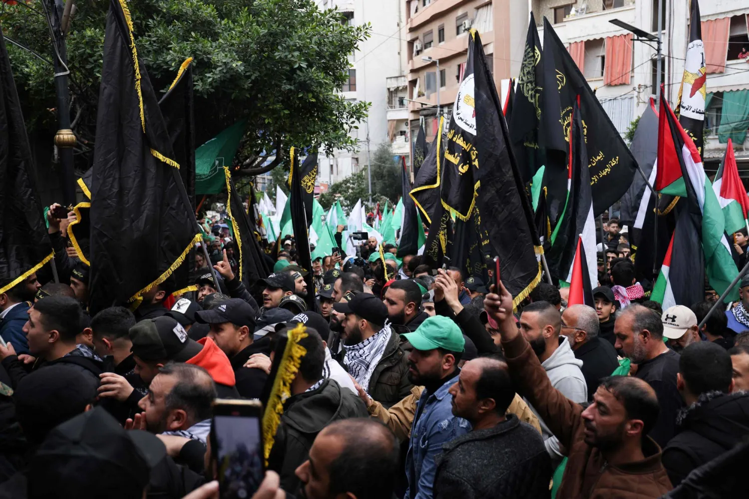 رايات حركة «الجهاد الإسلامي» خلال تشييع القيادي في حركة «حماس» صالح العاروري في بيروت (أ.ف.ب)