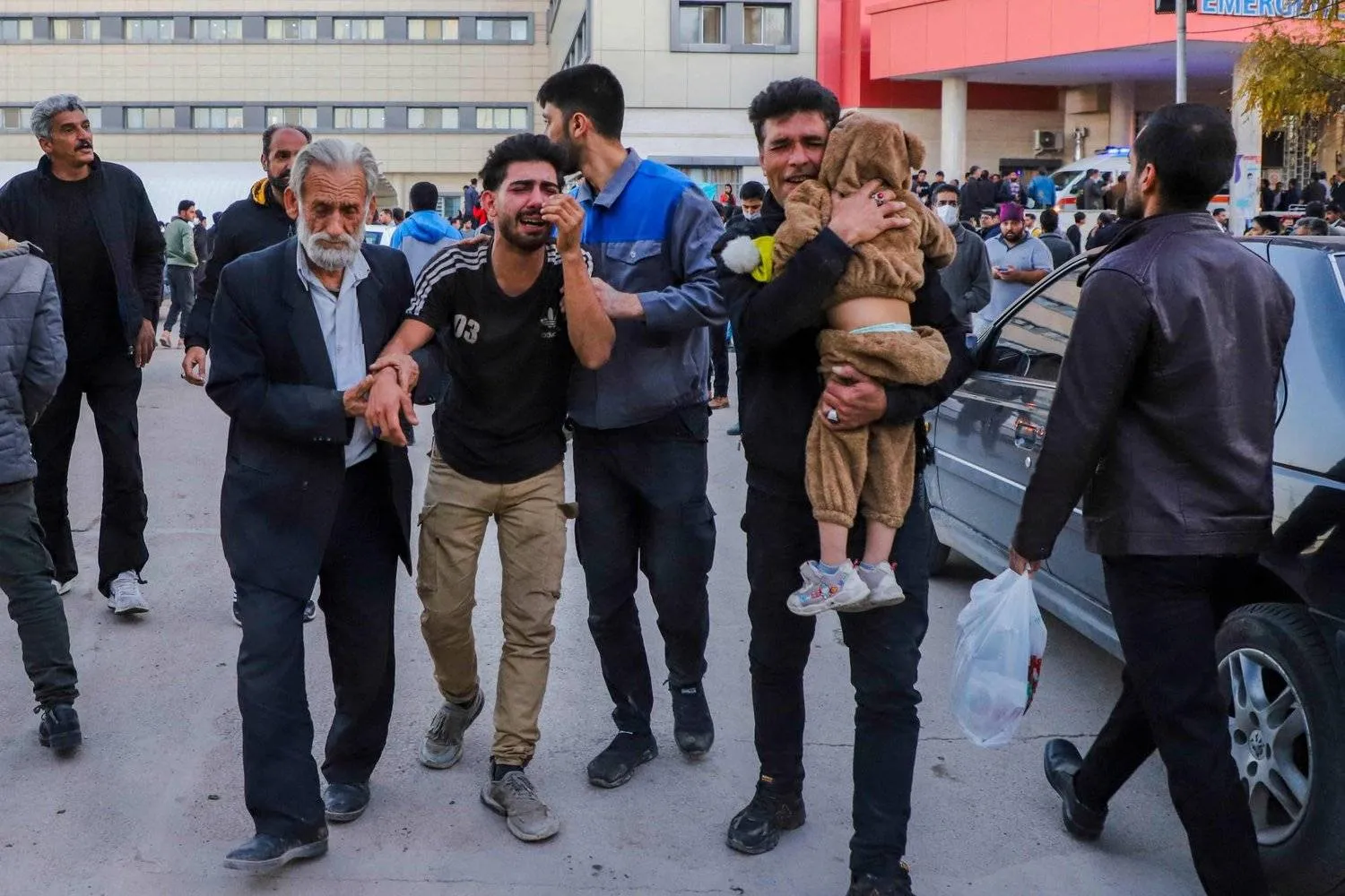 People injured in two explosions are helped outside a hospital in the southern Iranian city of Kerman on January 3, 2024. (Photo by SARE TAJALLI / ISNA / AFP)
