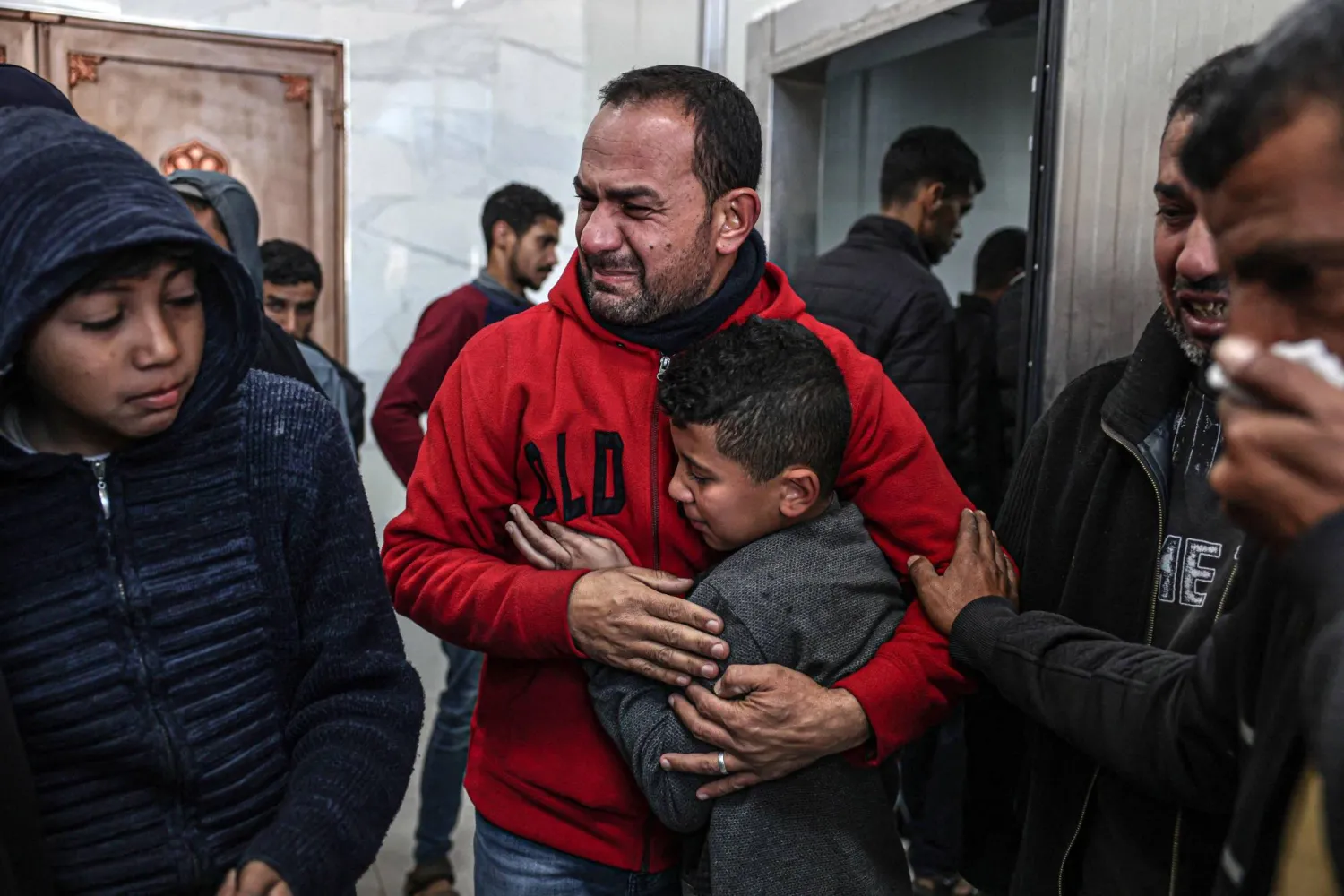 Relatives of Palestinians killed during Israeli bombardment, mourn their loved ones at the European hospital in Khan Yunis in the southern Gaza Strip, on January 6, 2024, amid continuing battles between Israel and Hamas. (Photo by AFP)