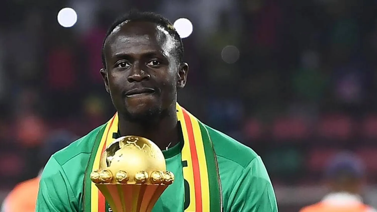 Senegal star Sadio Mane with the Africa Cup of Nations trophy after winning the 2022 final against Egypt. CHARLY TRIBALLEAU / AFP/File

