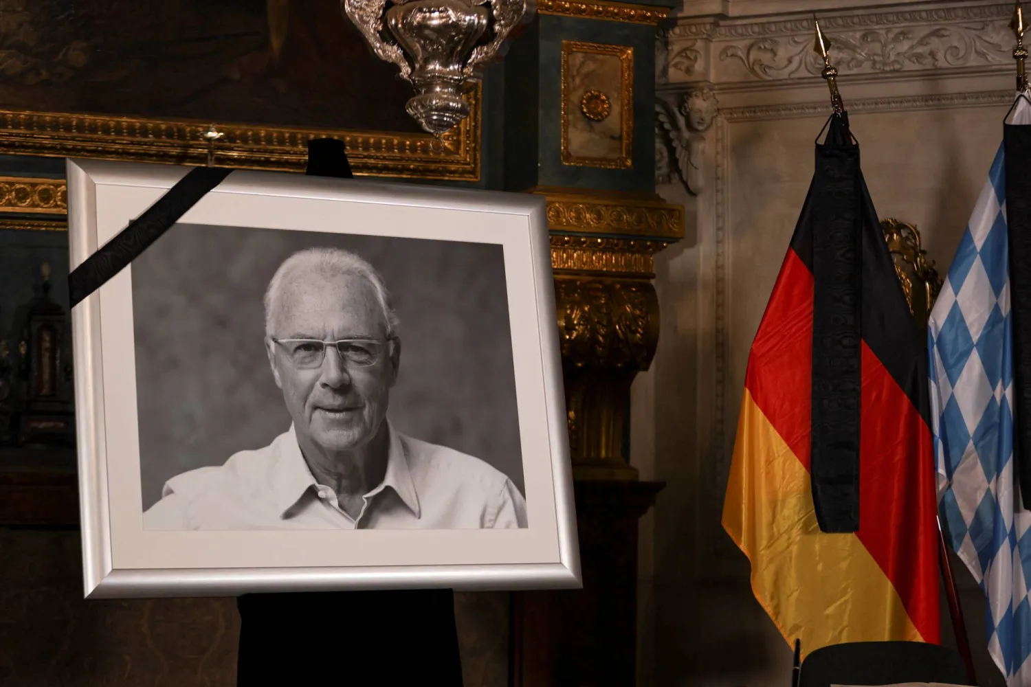 صورة أسطورة كرة القدم الألمانية الراحل فرانز بكنباور معروضة في كنيسة خلال حدث للتوقيع على كتاب تعزية (رويترز)