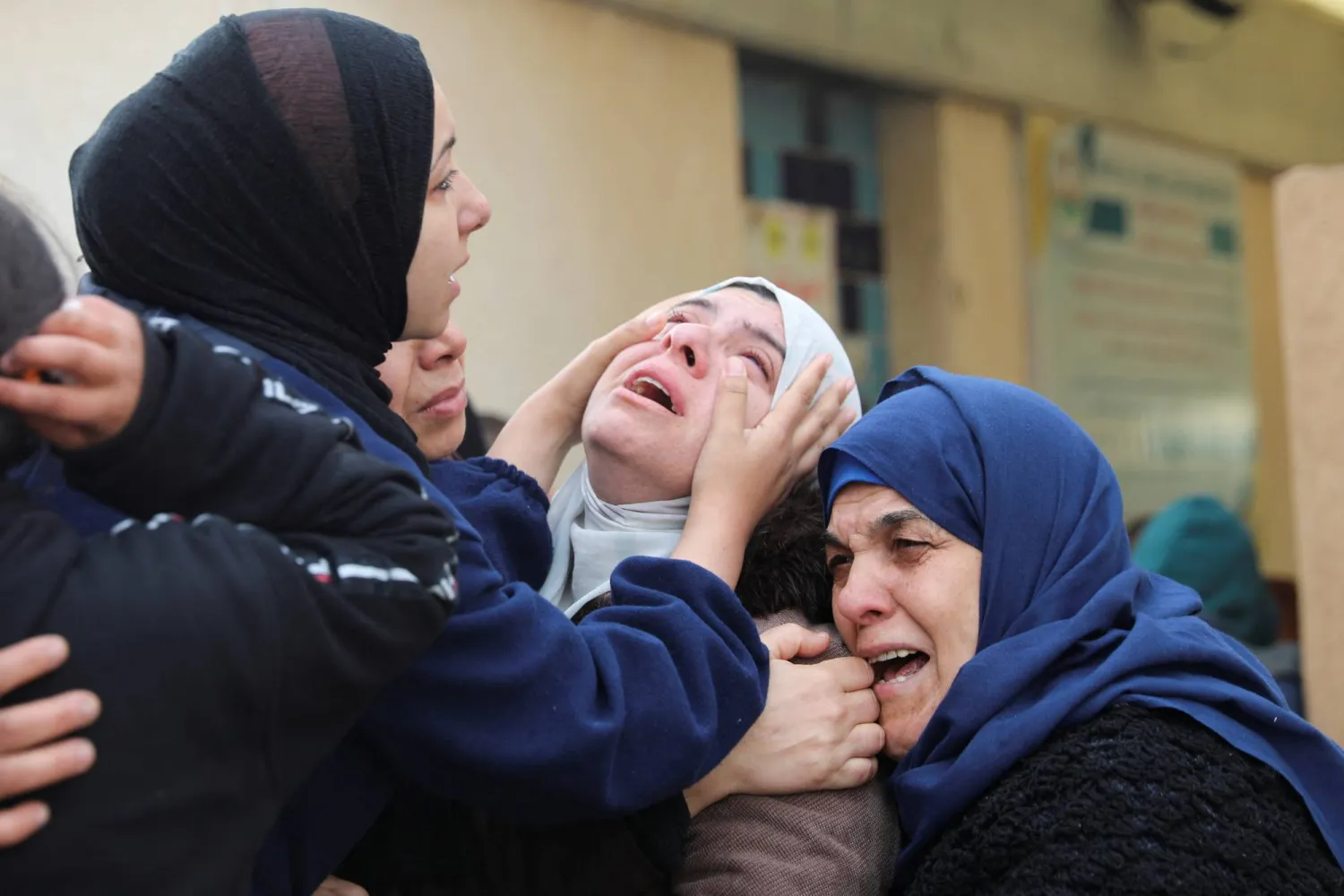 Mourners react during the funeral of Palestinians killed in an Israeli strike, amid the ongoing conflict between Israel and Hamas, in Khan Younis in the southern Gaza Strip, January 12, 2024. REUTERS/Arafat Barbakh