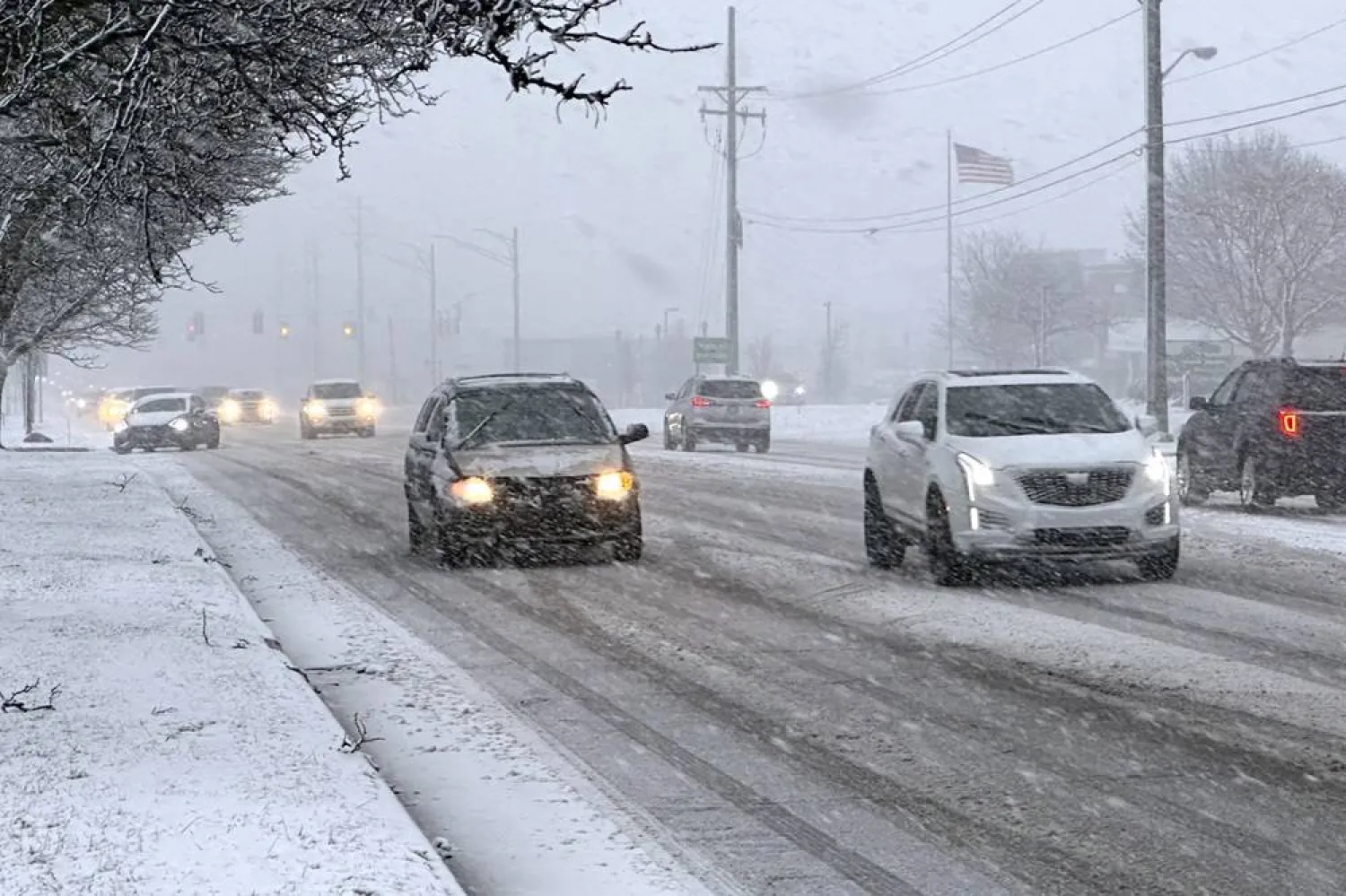 Early rush hour traffic is seen along Orchard Lake Road in West Bloomfield, Mich., shortly after the start of a winter storm Friday, Jan. 12, 2024. (AP)