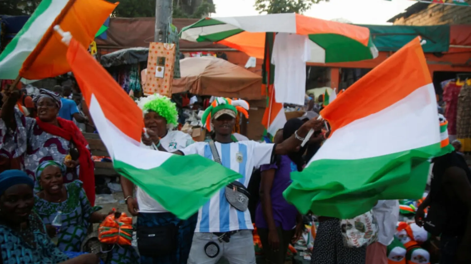 People celebrate in the streets as Ivory Coast gears up to host the Africa Cup of Nations which begins on Saturday January 13, 2024 in Abidjan, Ivory Coast. © Luc Gnago, Reuters
