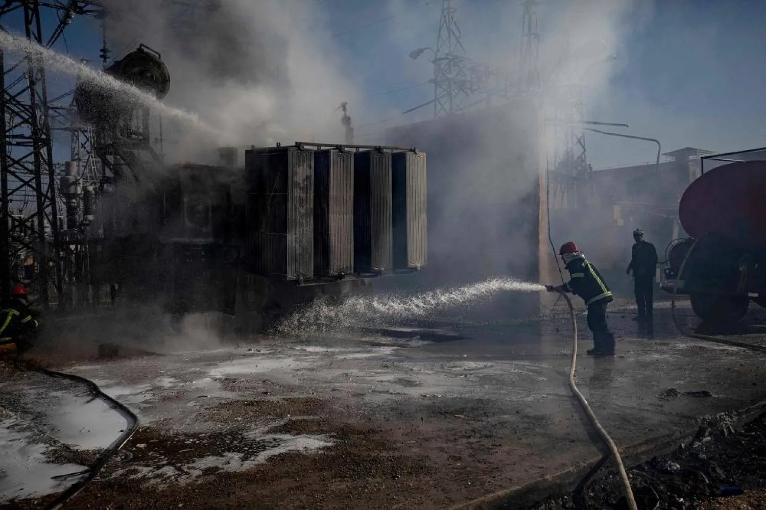 Kurdish Syrian firemen put out a blaze at a power station in Qamishli which was reportedly targeted by Turkish drones on January 15, 2024 as Türkiye carried out another series of airstrikes against Kurdish sites in northeastern Syria and northern Iraq in what Ankara said was a response for the deaths of nine Turkish soldiers. (AFP) 