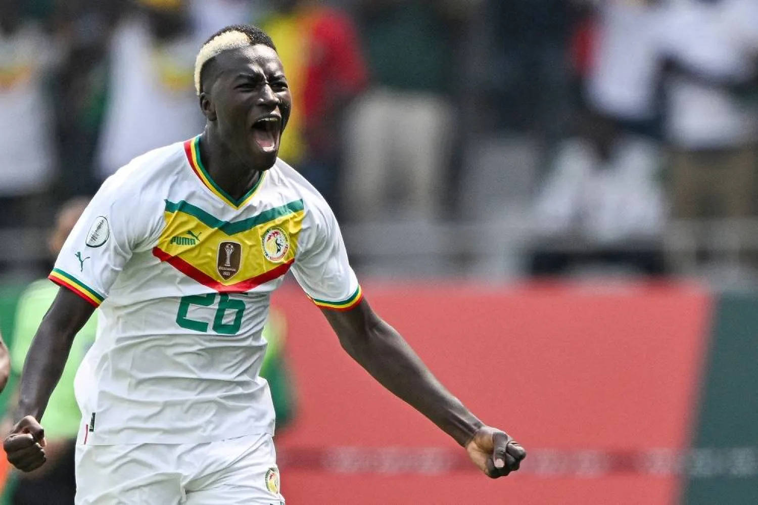 Senegal's midfielder #26 Pape Gueye celebrates scoring his team's first goal during the Africa Cup of Nations (CAN) 2024 group C football match between Senegal and Gambia at Stade Charles Konan Banny in Yamoussoukro on January 15, 2024. (AFP)