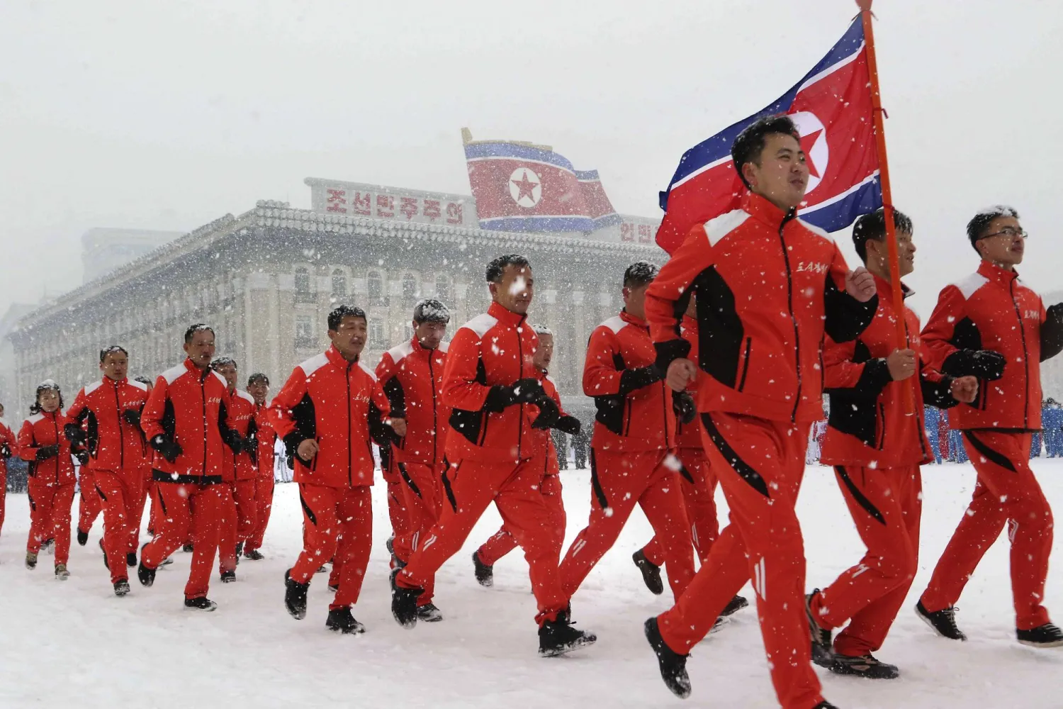 North Korea's officials of commissions, ministries and national institutions run at Kim Il Sung Square on the first sports day of the New Year in Pyongyang, North Korea, Sunday, Jan. 14, 2024. (AP Photo/Cha Song Ho)