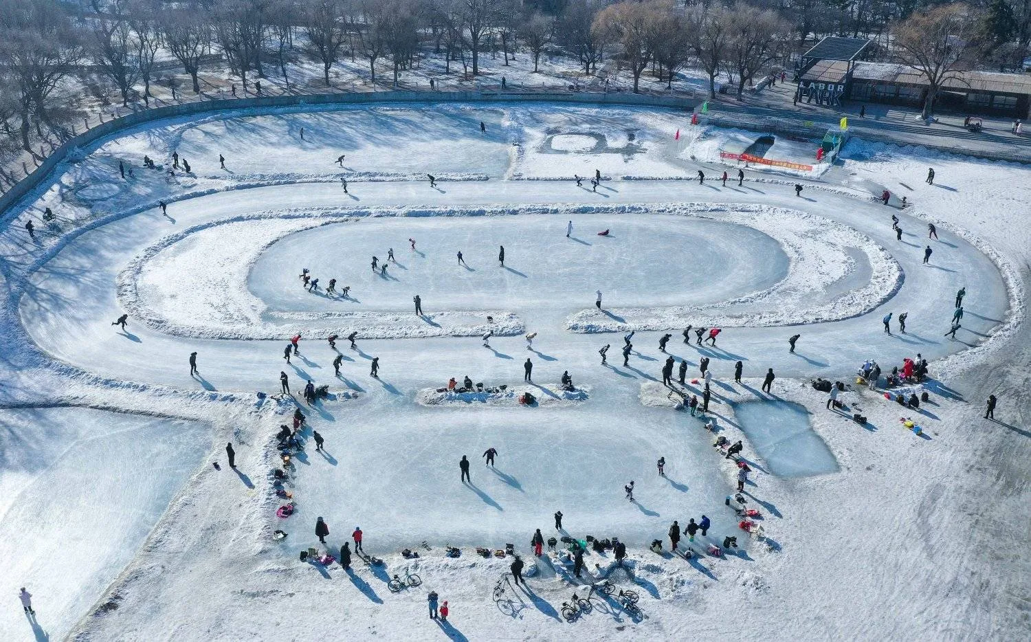 The aerial view shows people skating on a frozen lake at a park in Shenyang, in northeastern China's Liaoning province on January 18, 2024. (Photo by AFP) / China OUT