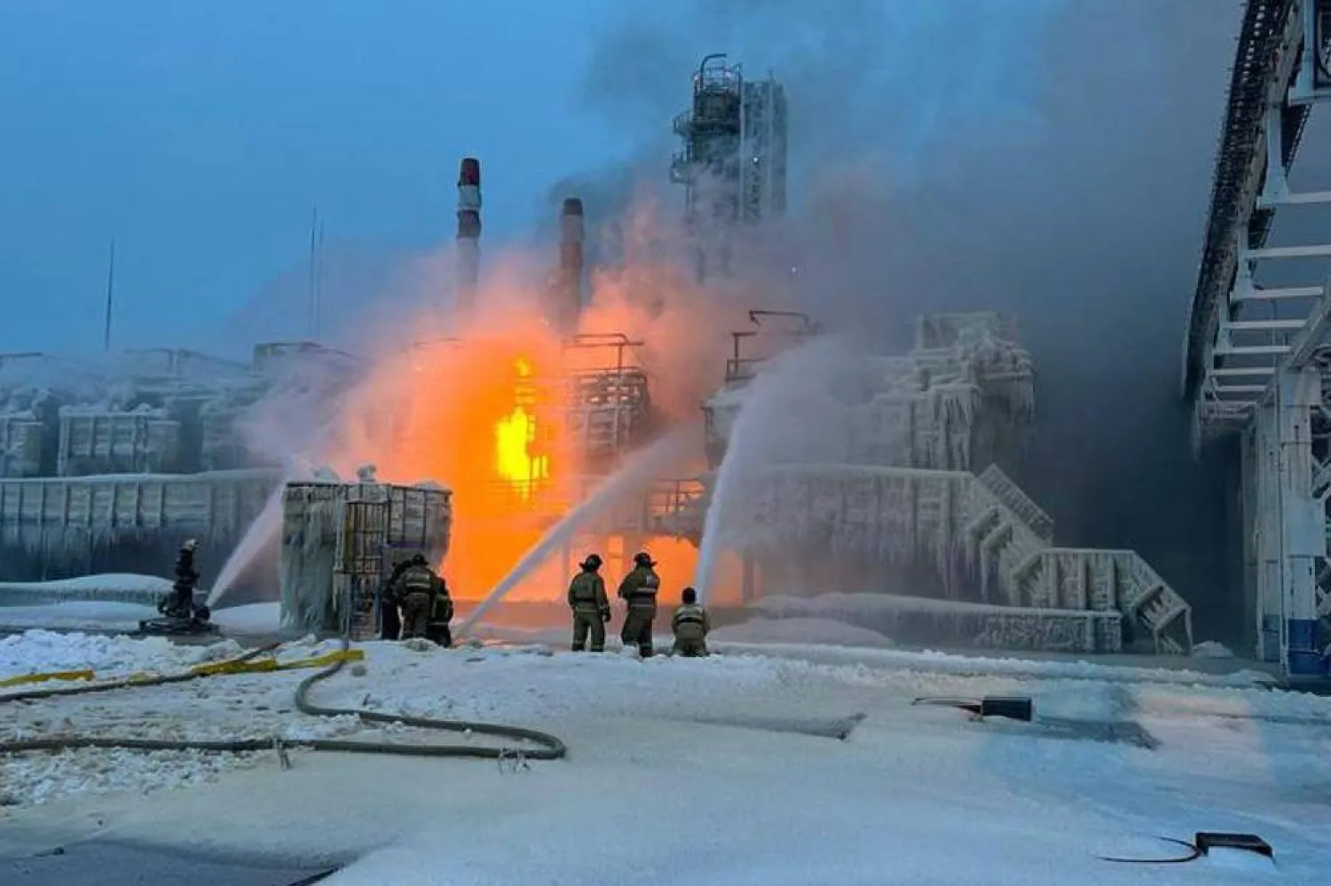 This handout photograph published on the official Telegram account of the governor of the Leningrad region Aleksandr Drozdenko on January 21, 2024, shows rescuers working to extinguish a fire at a natural gas terminal in the Russian Baltic Sea port of Ust-Luga. (Photo by Handout / Telegram / @drozdenko_au_lo / AFP)