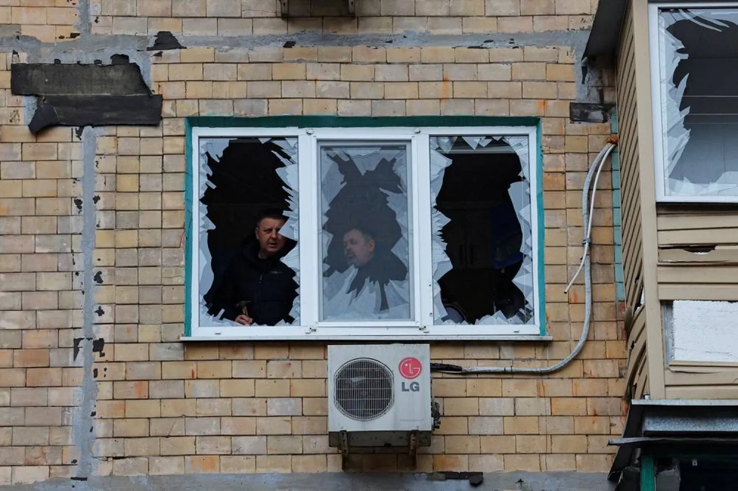  Local residents stand inside an apartment, which was damaged by recent shelling in the course of Russia-Ukraine conflict in the town of Horlivka (Gorlovka) in the Donetsk region, Russian-controlled Ukraine, January 20, 2024. (Reuters)