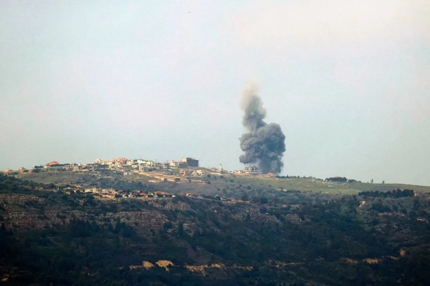 This picture taken from a position in northern Israel along the border with Lebanon on January 21, 2024 shows smoke billowing over the Lebanese village of Markaba during reported Israeli bombardment, amid ongoing cross-border tensions as fighting continues between Israel and Hamas militants in Gaza. (AFP)