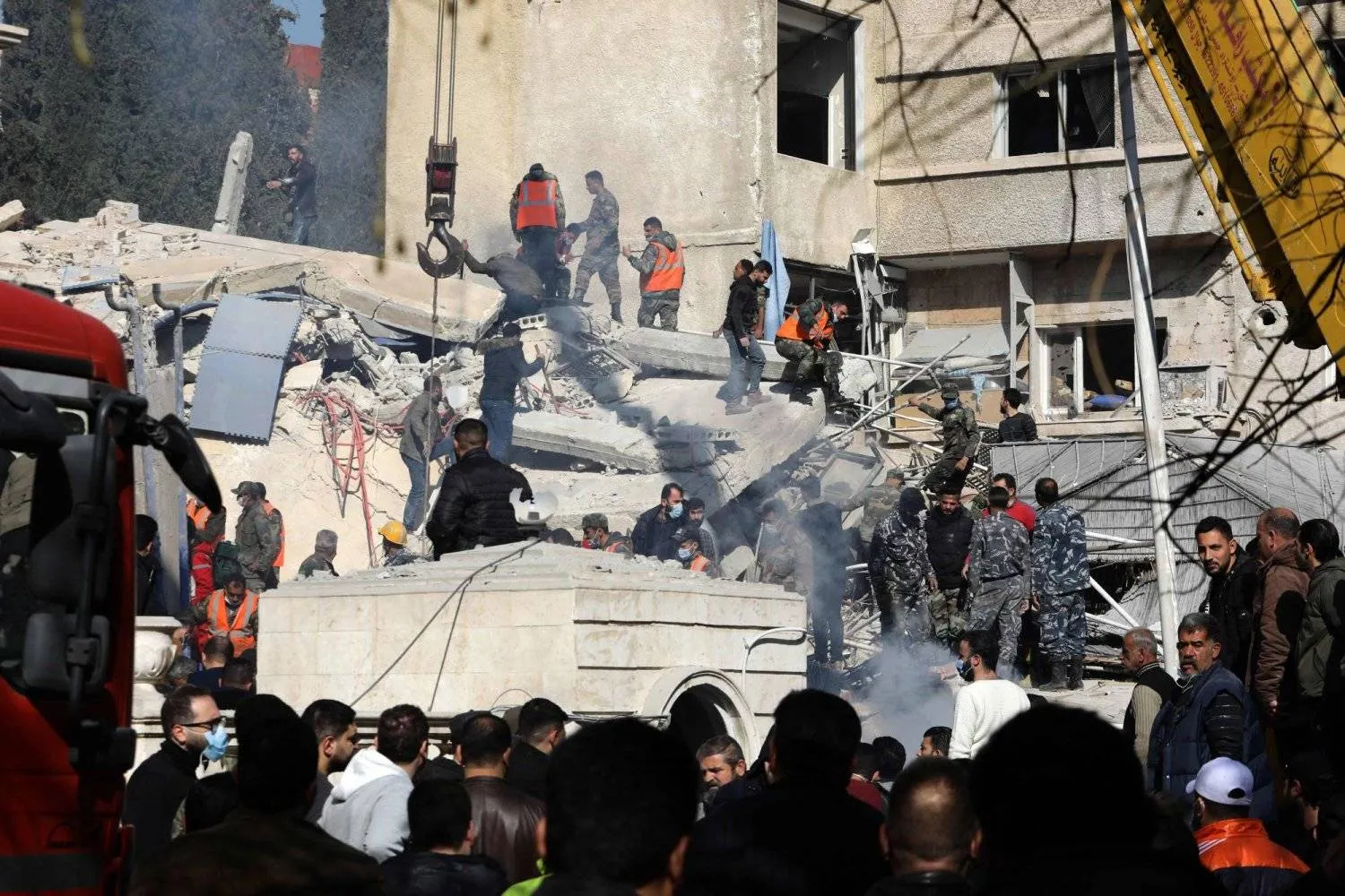 Syrian security and emergency personnel search through the rubble of a building destroyed in an Israeli airstrike that targeted a meeting of leaders from Iran’s Revolutionary Guard. (AFP) 