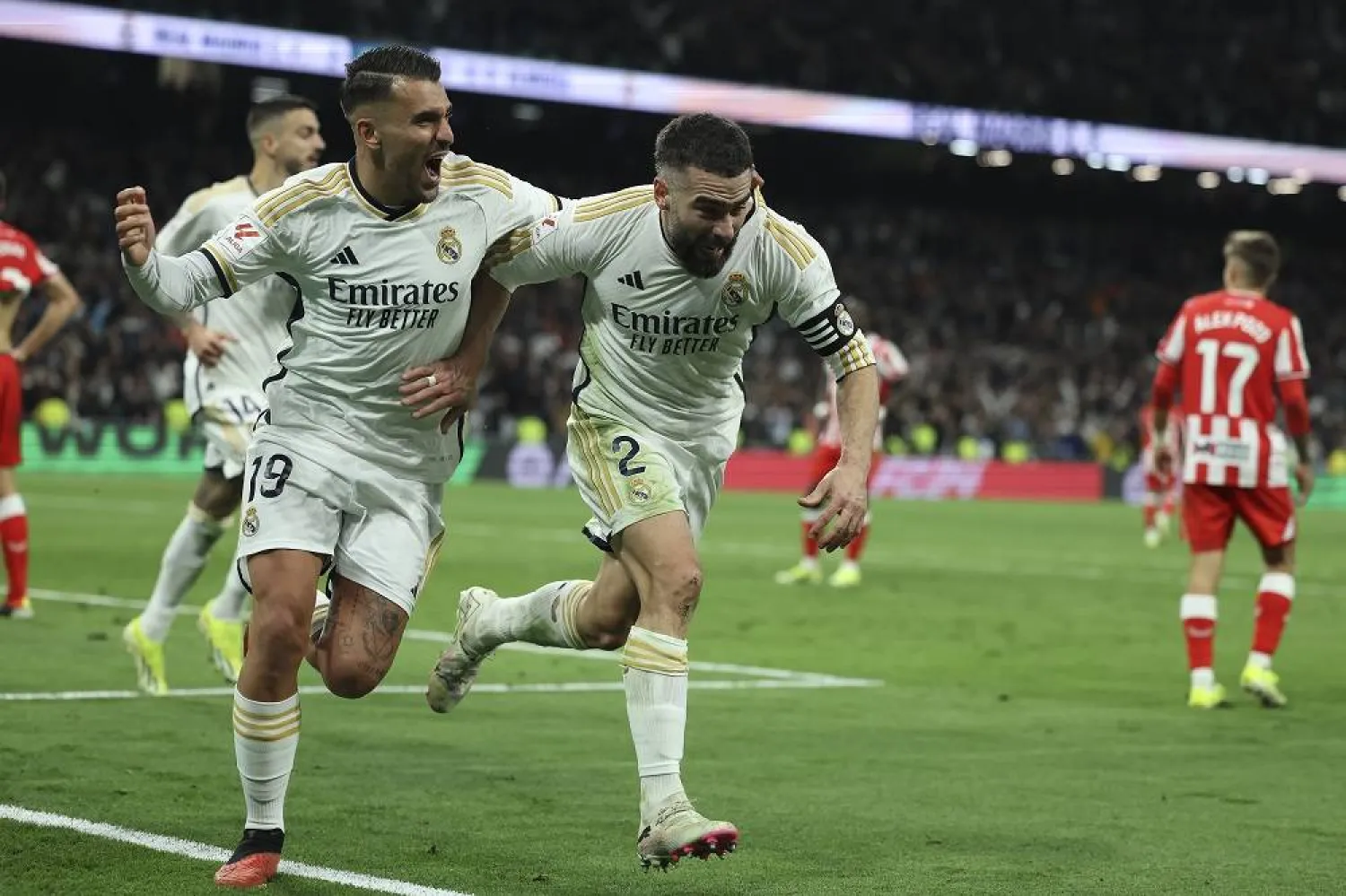 Real Madrid's defender Dani Carvajal (R) celebrates with his teammate Dani Ceballos (L) after scoring the 3-2 goal during the Spanish LaLiga soccer match between Real Madrid and UD Almeria, in Madrid, 21 January 2024. (EPA)