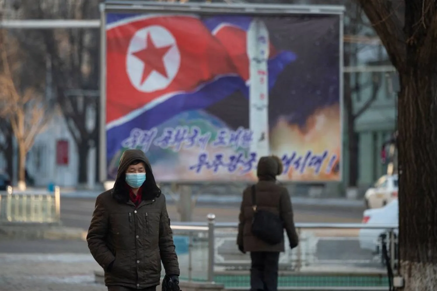 In this picture taken on January 23, 2024, people walk along Sungri street in Pyongyang. (AFP)