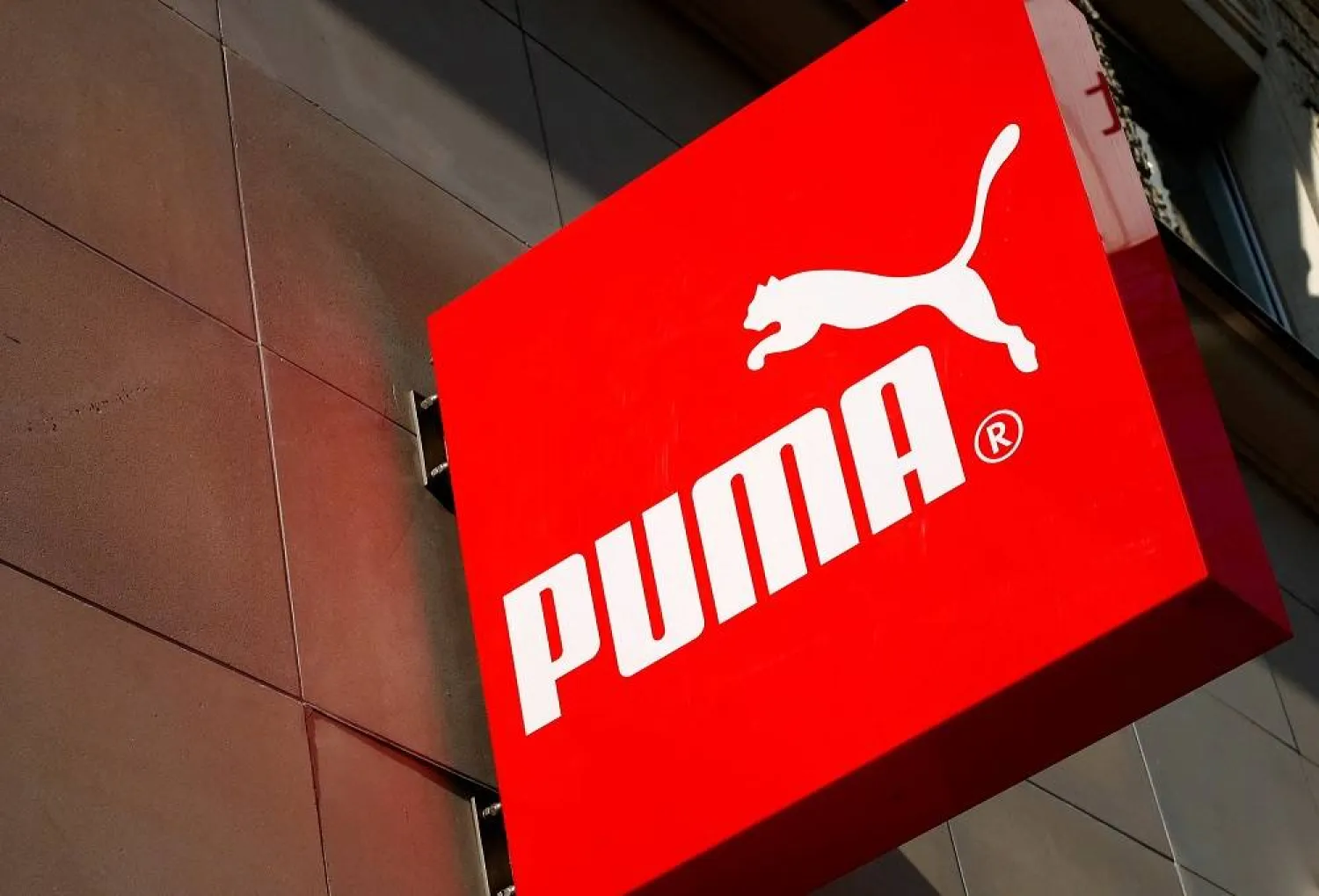 The logo of German sports goods firm Puma is seen at the entrance of one of its stores in Vienna, Austria, March 18, 2016. (Reuters)