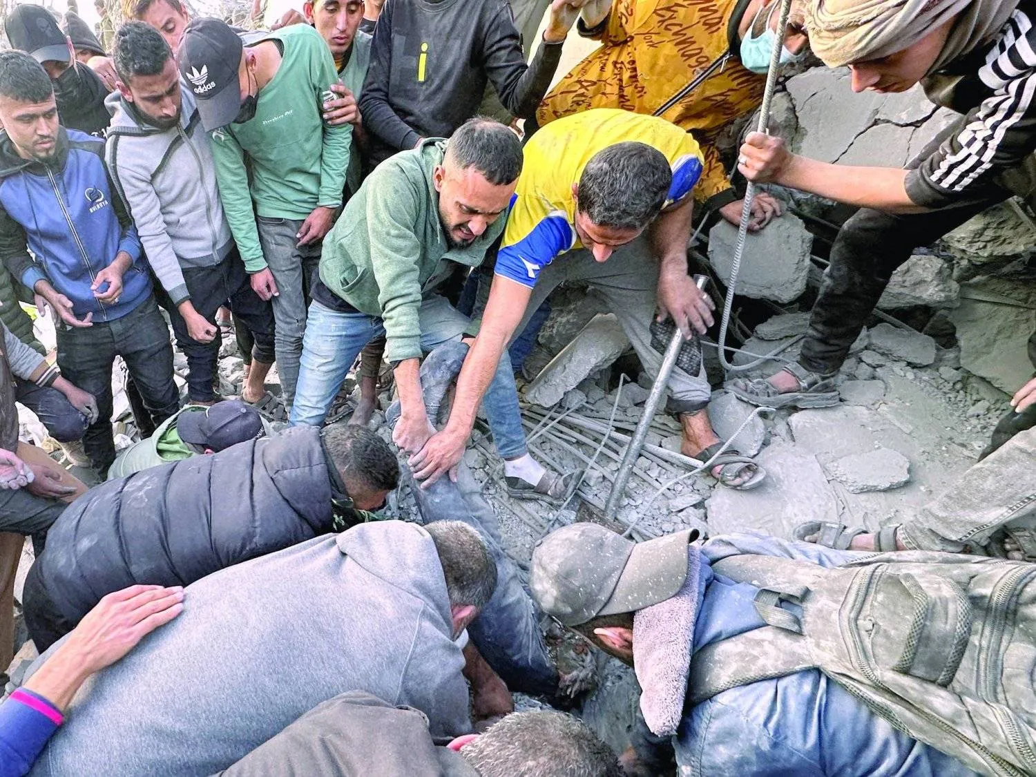 Palestinians inspect the damage after a strike on a mosque, which had been reduced to rubble - Reuters