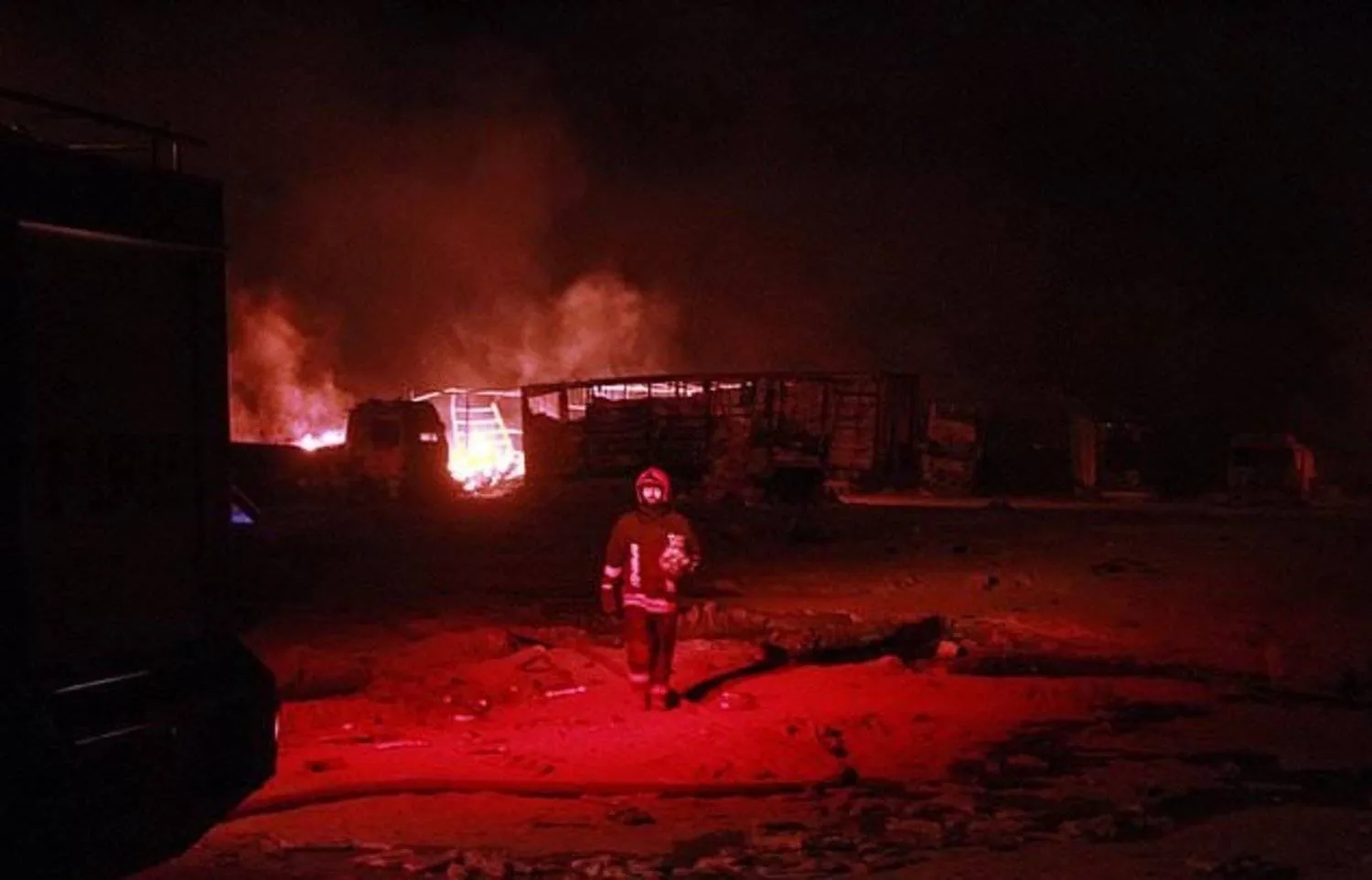 One of the Iranian firefighters works on a burning tanker carrying fuel at the Islam Qala border with Iran, in Herat Province, west of Kabul, Afghanistan, Saturday, Feb. 13, 2021. (FILE:AP Photo/Hamed Sarfarazi)
