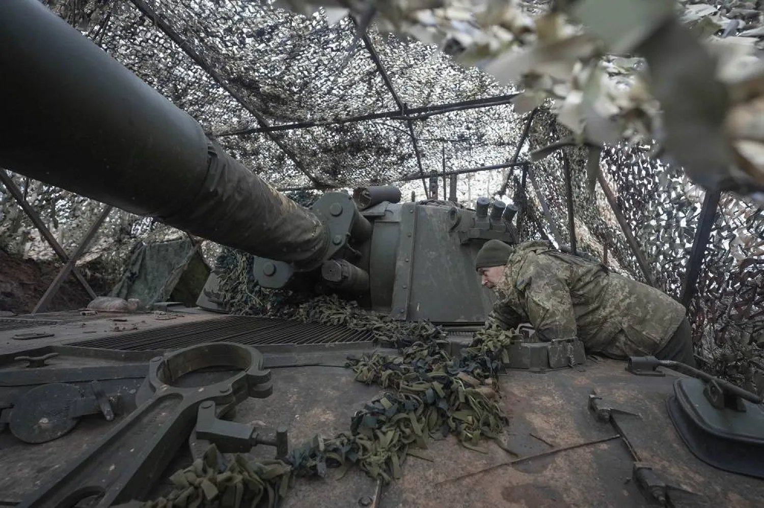 A soldier of the 12th Special Forces Brigade Azov of the National Guard prepares to fire a 155mm self-propelled gun M109 Paladin, towards Russian positions at the front line, near Kreminna, Luhansk region, Ukraine, Sunday, Jan. 28, 2024. (AP)