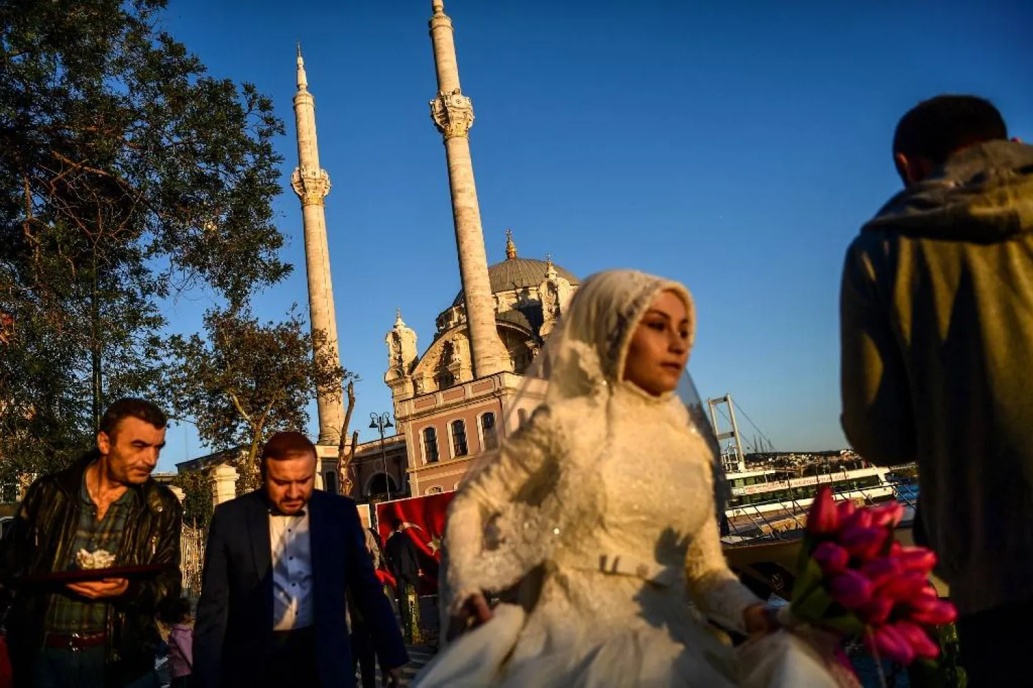  A bride and groom walk as they get ready for wedding pictures (AFP)