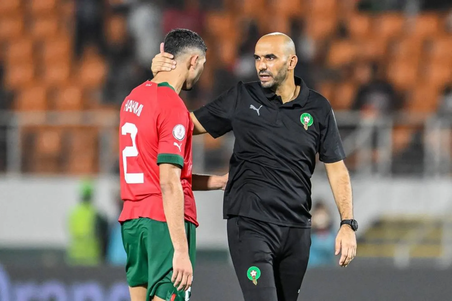 Morocco's coach Walid Regragui (R) and Morocco's defender #2 Achraf Hakimi (L) react after their loss in the Africa Cup of Nations (CAN) 2024 round of 16 football match between Morocco and South Africa at the Stade Laurent Pokou in San Pedro on January 30, 2024. (AFP)